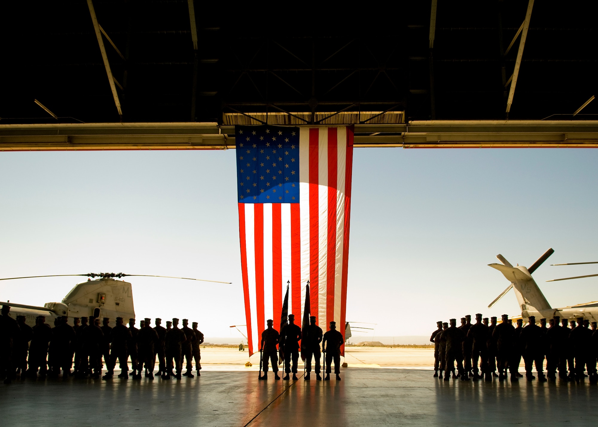 Marines stand at parade rest during a change of command ceremony for Marine Aircraft Group 46 Detachment Bravo at hangar 1210 here June 12. Marine Lt. Col. Christopher Keane succeeds Lt. Col. Thomas McCarthy as commander. (Air Force photo by Mike Cassidy)
