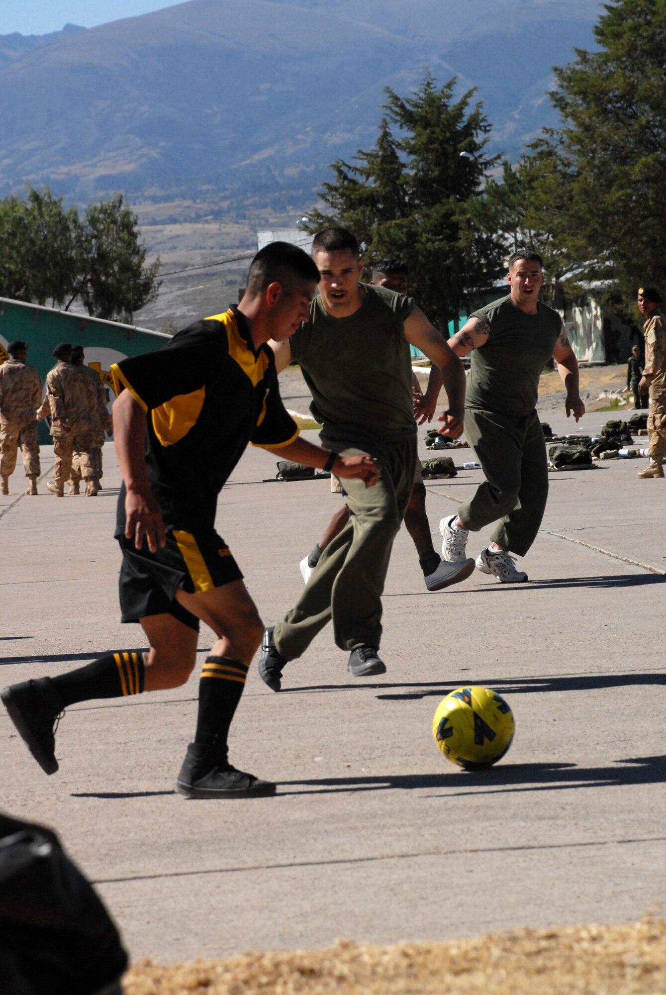 U.S. Marine Lance Cpl. Matthew Carroll, assigned to Task Force New Horizons, attempts to steal the ball from a Peruvian soldier during a soccer game, June 8, on a Peruvian Army base in Ayacucho, Peru, the region benefiting from the humanitarian efforts of New Horizons Peru-2008. New Horizons is a U.S. and Peruvian partnered effort to help underprivileged Peruvians by building schools, clinics, and wells. (U.S. Air Force photo/Airman 1st Class Tracie Forte)