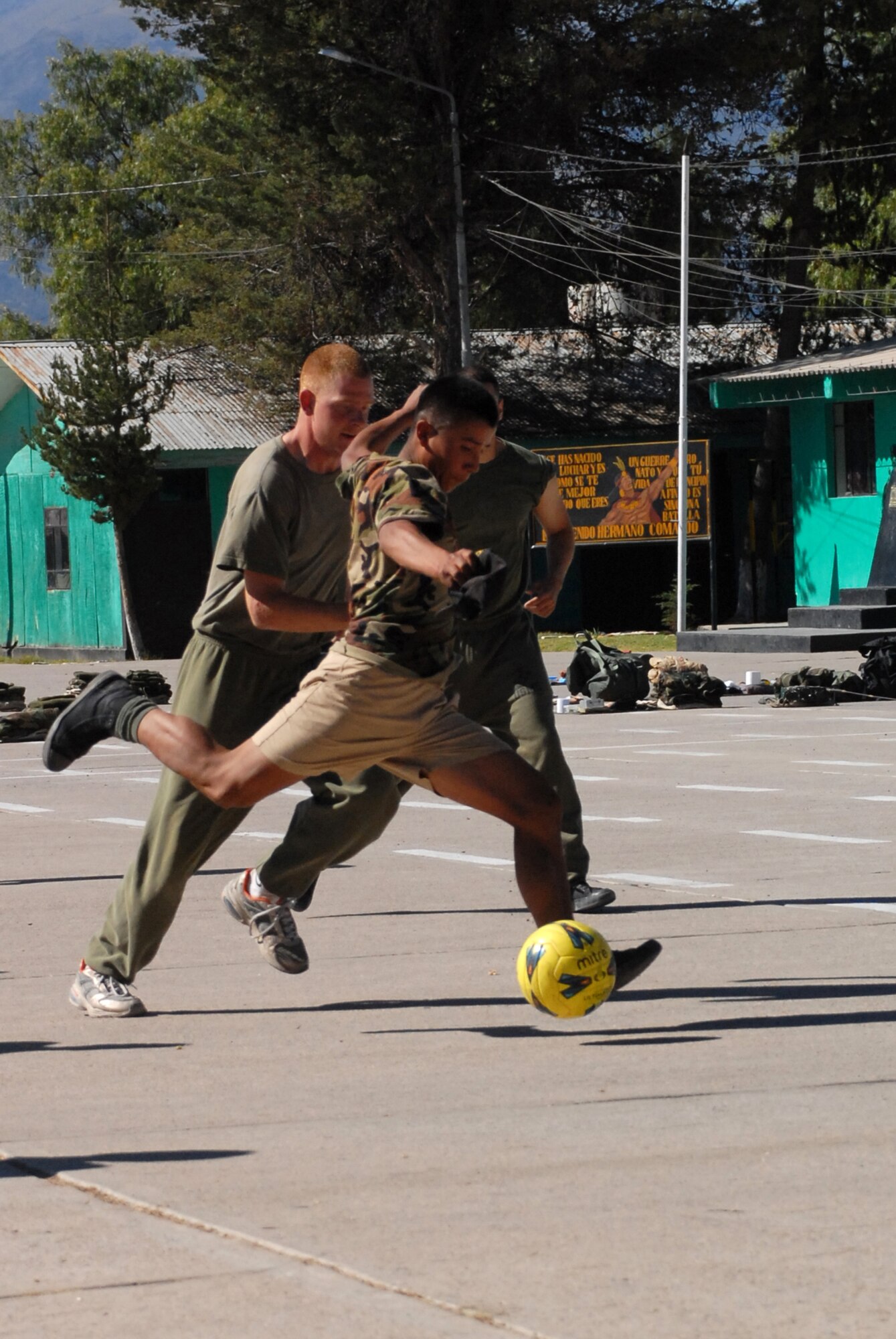 A Peruvian soldier attempts to score a goal against U.S. servicemembers, assigned to Task Force New Horizons, during a soccer game, June 8, on a Peruvian Army base in Ayacucho, Peru, the region benefiting from the humanitarian efforts of New Horizons Peru-2008. New Horizons is a U.S. and Peruvian partnered effort to help underprivileged Peruvians by building schools, clinics, and wells. (U.S. Air Force photo/Airman 1st Class Tracie Forte)