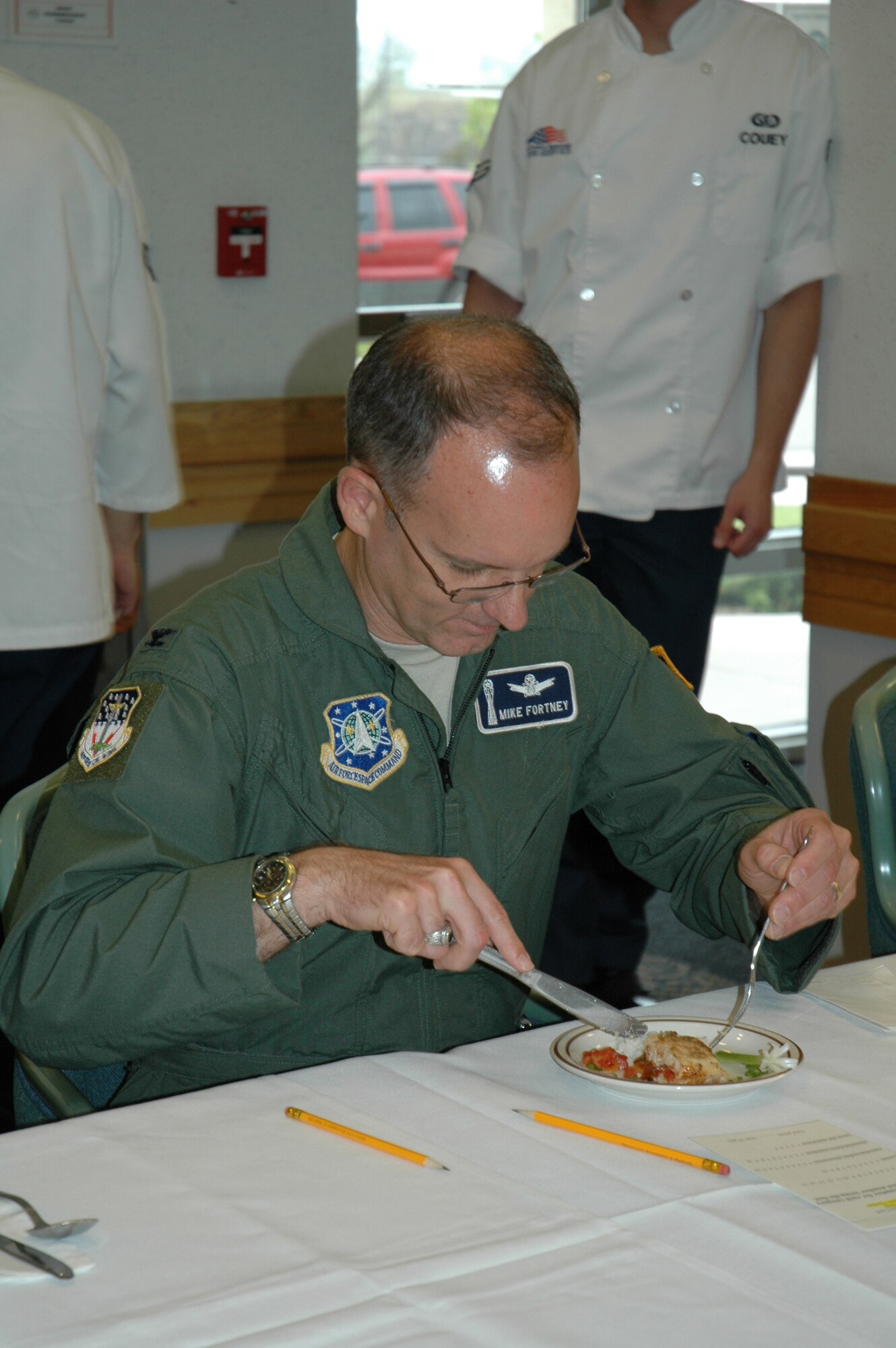Col. Michael Fortney, 341st Space Wing commander, samples the Monterey chicken prepared by members of the 341st Services Squadron at the Warrior Chef competition at the Elkhorn Diner June 10. (U.S. Air Force photo/Airman 1st Class Emerald Ralston)