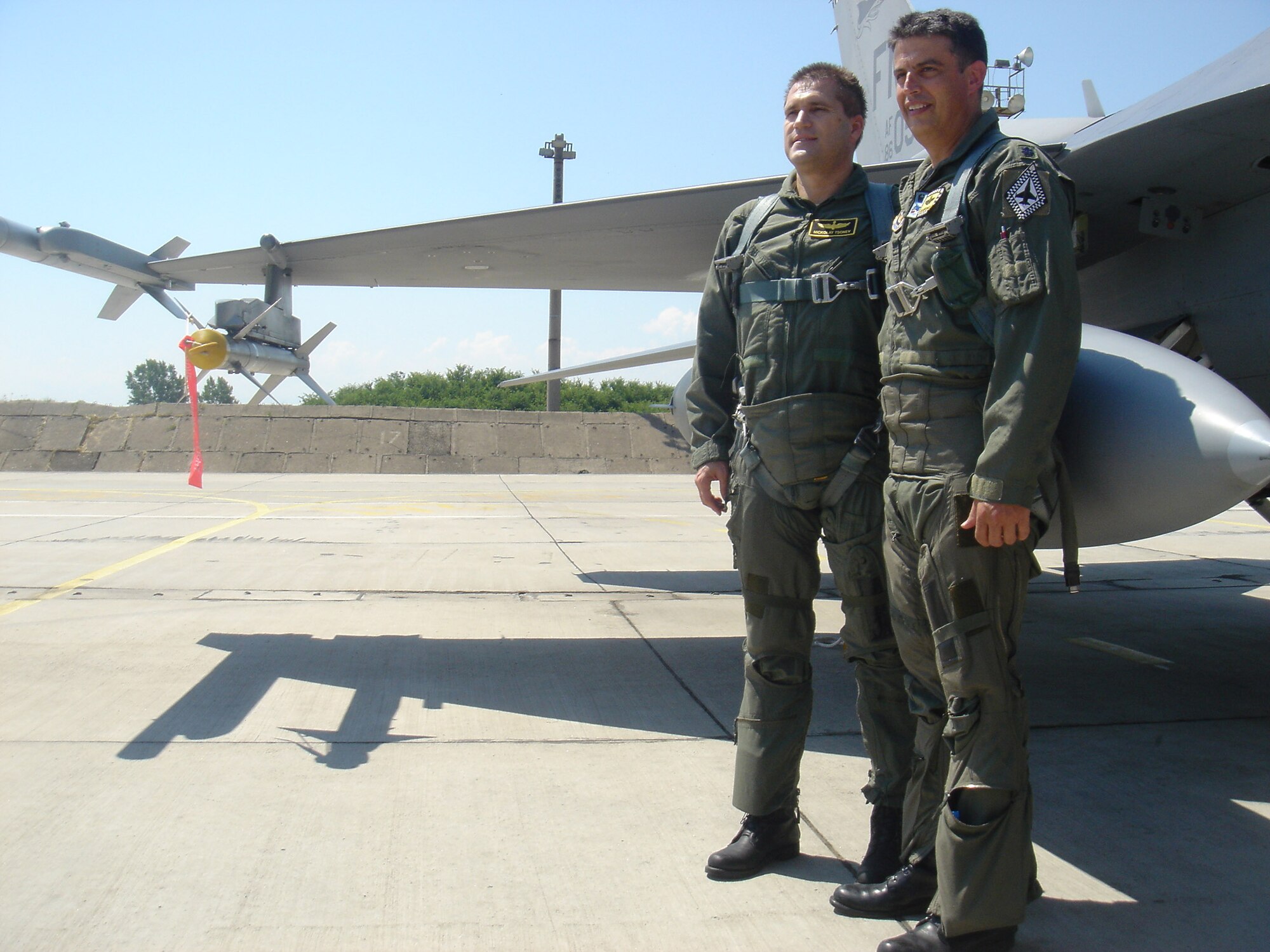Lt. Col. Jose Monteagudo (right), an F-16 pilot from the 482nd Fighter Wing, poses with Bulgarian Defense Minister Nikolay Tsonev (left) before taking him on a flight in an F-16 Fighting Falcon. Colonel Monteagudo and 10 F-16 fighter jets from the 93rd Fighter Squadron at Homestead Air Reserve Base, Fla. are here at Graf Ignatievo Air Base, Bulgaria to particpate in a joint drill with 15 Bulgarian MiG-21 and MiG-29 fighters. MInister Tsenov visited the base to see how the joint drill was progressing. (Courtesy photo by Darik Plovdiv)
