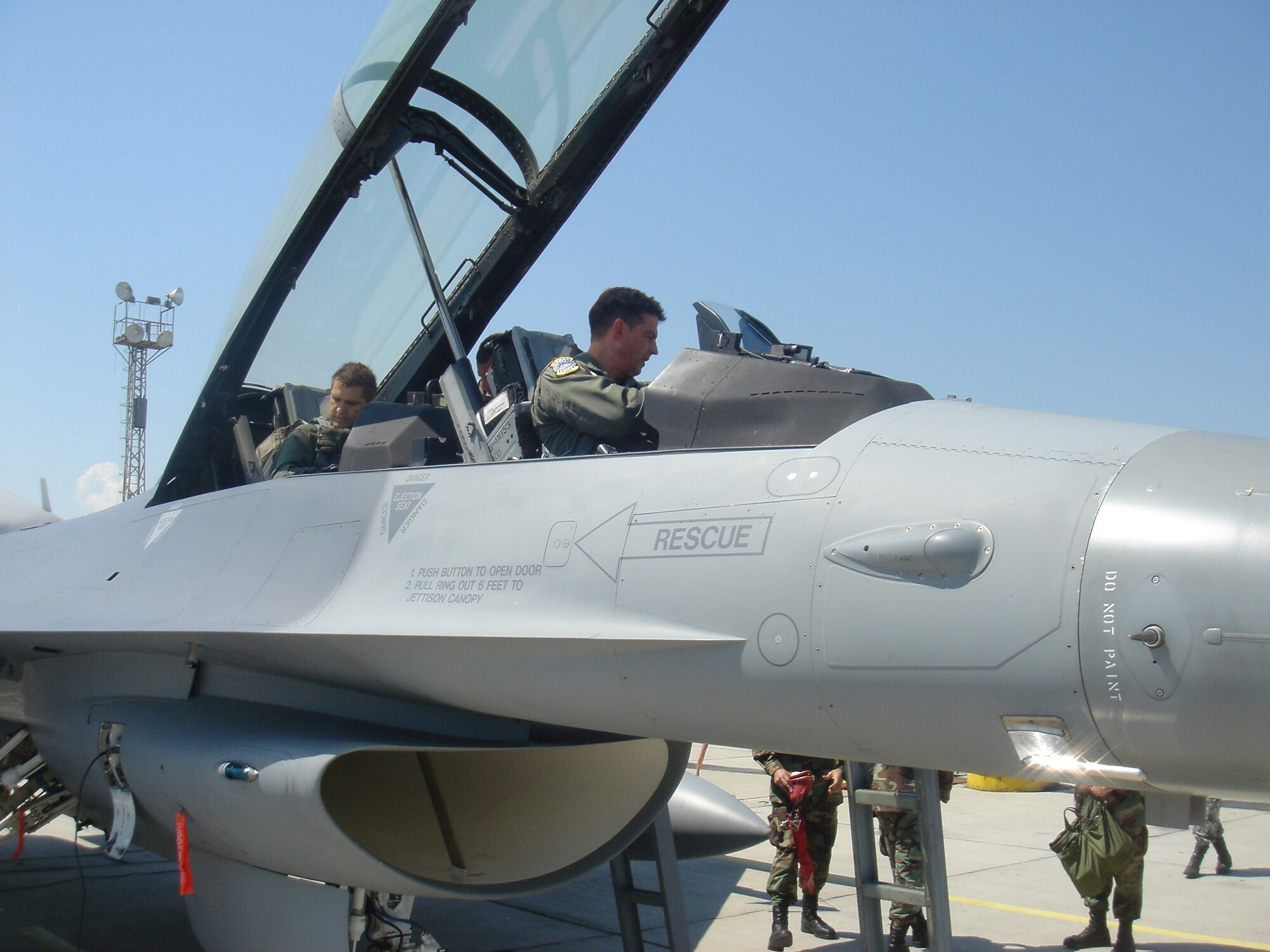 Lt. Col. Jose Monteagudo, an F-16 pilot from the 482nd Fighter Wing, prepares to take Bulgarian Defense Minister Nikolay Tsonev (backseat) on a flight in an F-16 Fighting Falcon. Colonel Monteagudo and 10 F-16 fighter jets from the 93rd Fighter Squadron at Homestead Air Reserve Base, Fla. are here at Graf Ignatievo Air Base, Bulgaria to particpate in a joint drill with 15 Bulgarian MiG-21 and MiG-29 fighters. MInister Tsenov visited the base to see how the joint drill was progressing. (Courtesy photo by Darik Plovdiv)