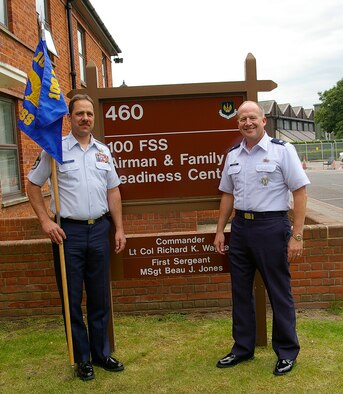 Lt. Col. Richard Wagner, right, the first commander of the newly-designated 100th Force Support Squadron, stands beside the newly unveiled sign in front of Building 460, June 13. Master Sgt. Thomas Green, the acting first sergeant, holds the unit's guidon. The unit was formed as part of an ongoing Air Force-wide merger of mission support and services squadrons. (U.S. Air Force photo by Karen Abeyasekere)
