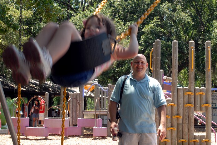 Tech. Sgt. Greg Edwards pushes his daughter Ivey, 4, on the swingset at the picnic grounds during the MatchUP base picnic June 6. Sergeant Edwards is assigned to the 20th Civil Engineer Squadron at Shaw AFB, S.C. (U.S. Air Force photo/Senior Airman Sam Hymas)