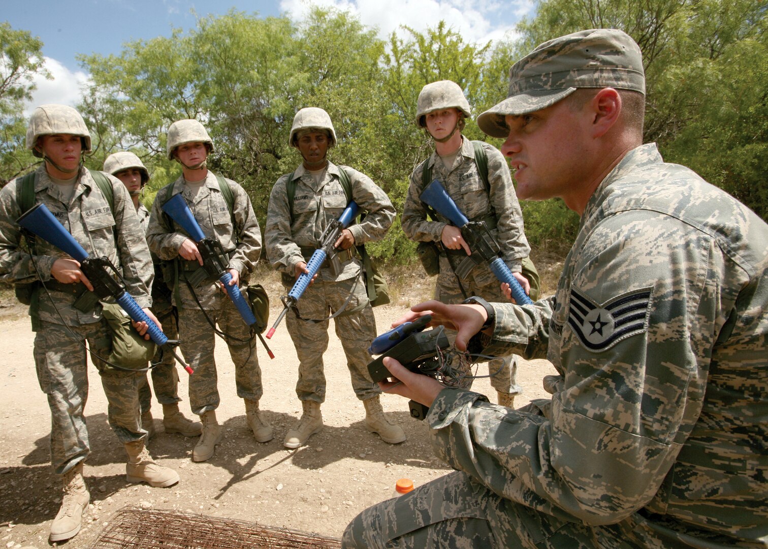6/9/2008 - Staff Sgt. Andrew Crabtree, 37th Training Support Squadron, discusses a simulated explosive with basic trainees.  Each time students encounter a simulated explosive, instructors analyze and discuss it with the training group, covering the specific location, type and situation to heighten IED awareness.
(USAF photo by Robbin Cresswell)
