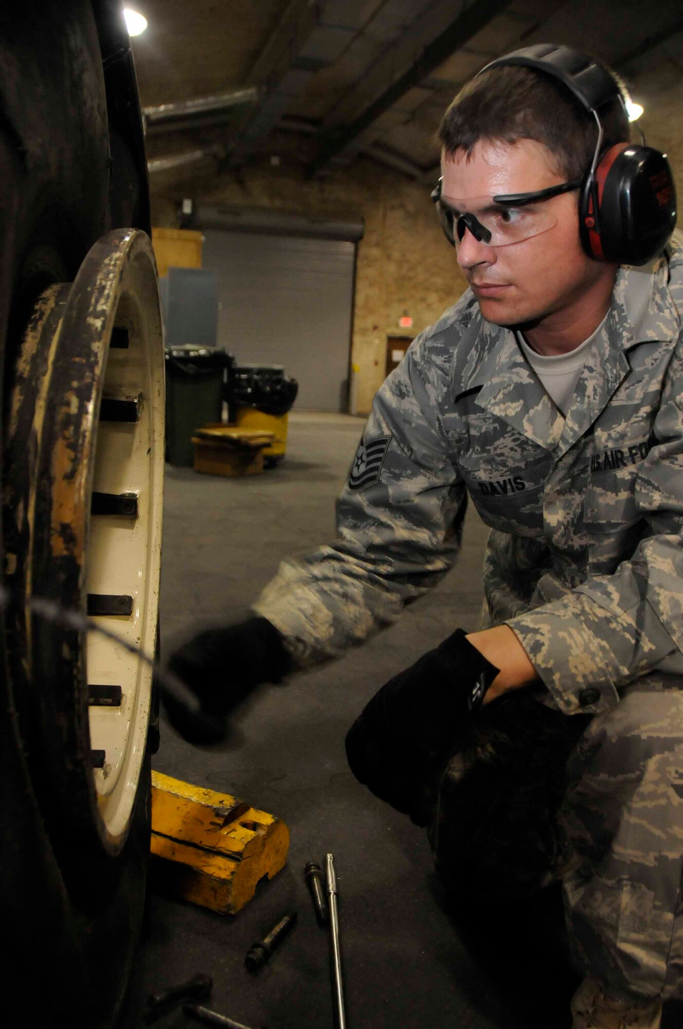 SOUTHWEST ASIA-- Technical Sgt. John Davis removes a piece of the tire, on a blown out wheel assembly June 7. An adverage wheel assembly takes 14-16 hours to rebuild. (U.S. Air Force photo/Senior Airman Domonique Simmons)