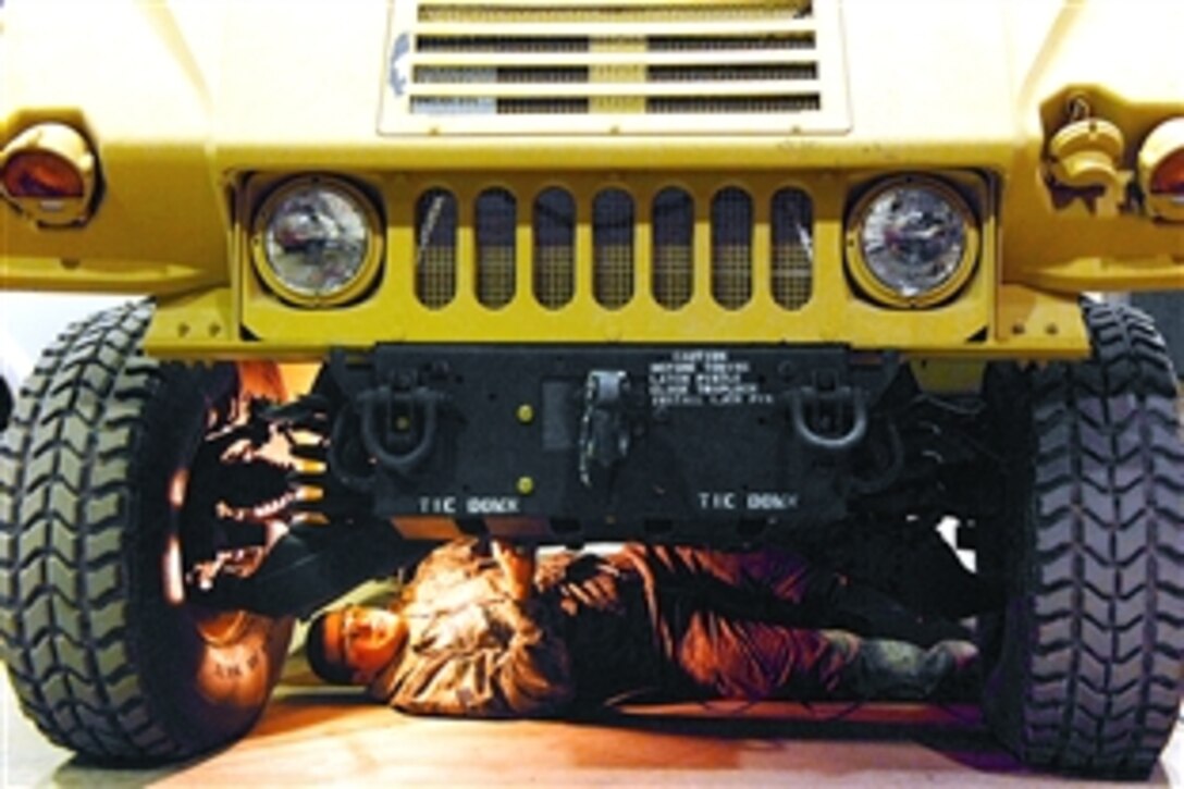 U.S. Air Force Senior Airman James Valdiviez inspects the undercarriage of a new Humvee at Balad Air Base, Iraq, June 4, 2008. The Humvees must be fully operational before they are released to the unit. Valdiviez is deployed from Eielson Air Force Base, Alaska. 