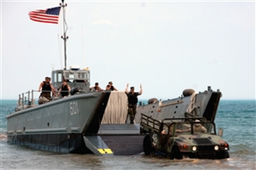 A U.S. Navy Landing Craft Mechanized 501 and the Surfriders from Assault Craft Unit One perform an on-load of a Marine Corps vehicle assigned to Reserve Marine Air Control Group 48, Naval Station Great Lakes, Ill., June 7, 2008. 