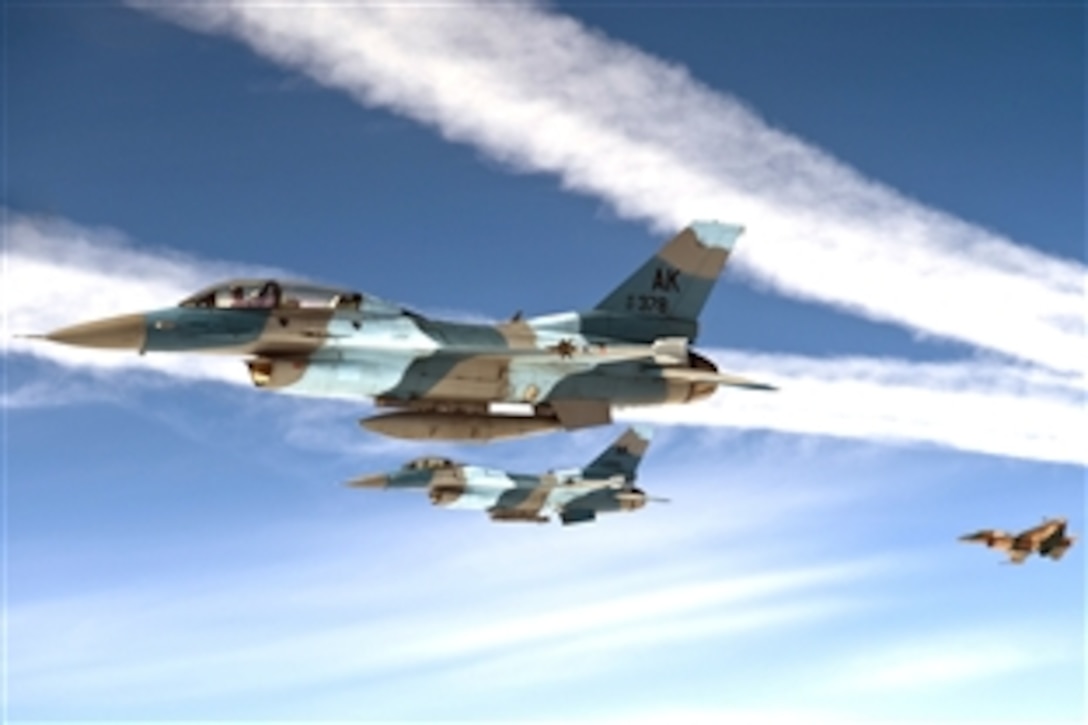 Three F-16 Aggressor aircraft fly in formation after receiving fuel during a mission in support of Red Flag-Alaska on Eielson Air Force Base, Alaska, June 10, 2008. The 10-day exercise involves realistic air combat training over the Alaskan and Western Canadian airspace. 