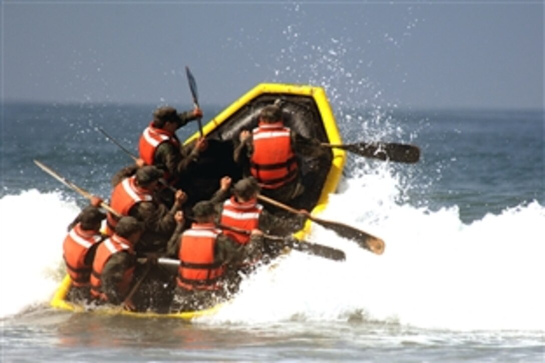 Basic Underwater Demolition/SEAL students battle through the surf during their last day of Hell Week at Naval Special Warfare Center, Coronado, Calif., June 6, 2008. All BUD/S students must complete Hell Week before progressing to the next phase of the year-long training program to become Navy SEALs. 