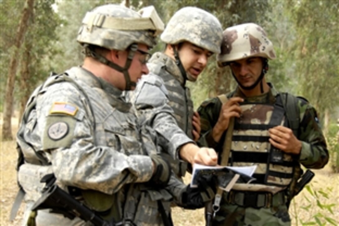 U.S. soldiers look over a map with an Iraqi soldier before starting a cordon and search of the Ninewa Forest in Mosul, Iraq, June 8, 2008. The U.S. soldiers are assigned to the 3rd Squadron, 3rd Armored Cavalry Regiment.