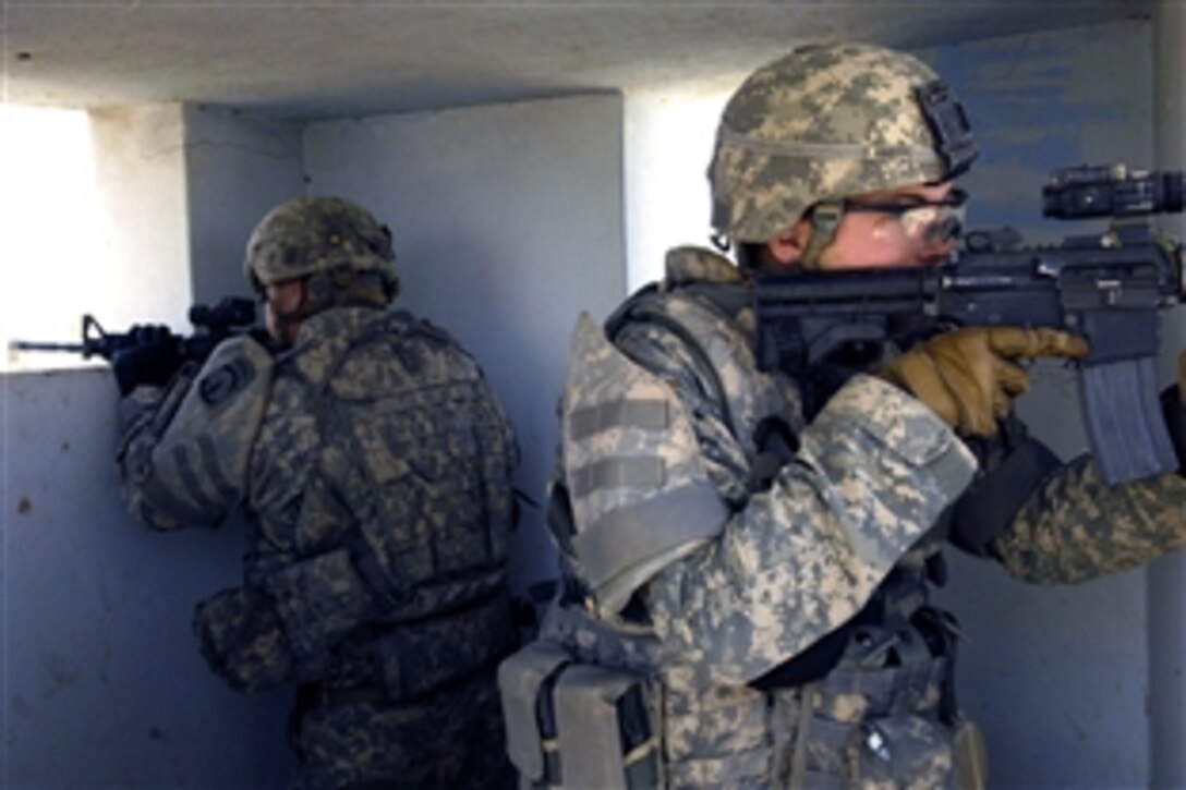 U.S. soldiers provide rooftop security for their dismounted team during a routine inspection of a police station in Ad Diwaniyah, Iraq, June 10, 2008. The soldiers are assigned to the 10th Mountain Division Military Police.  
