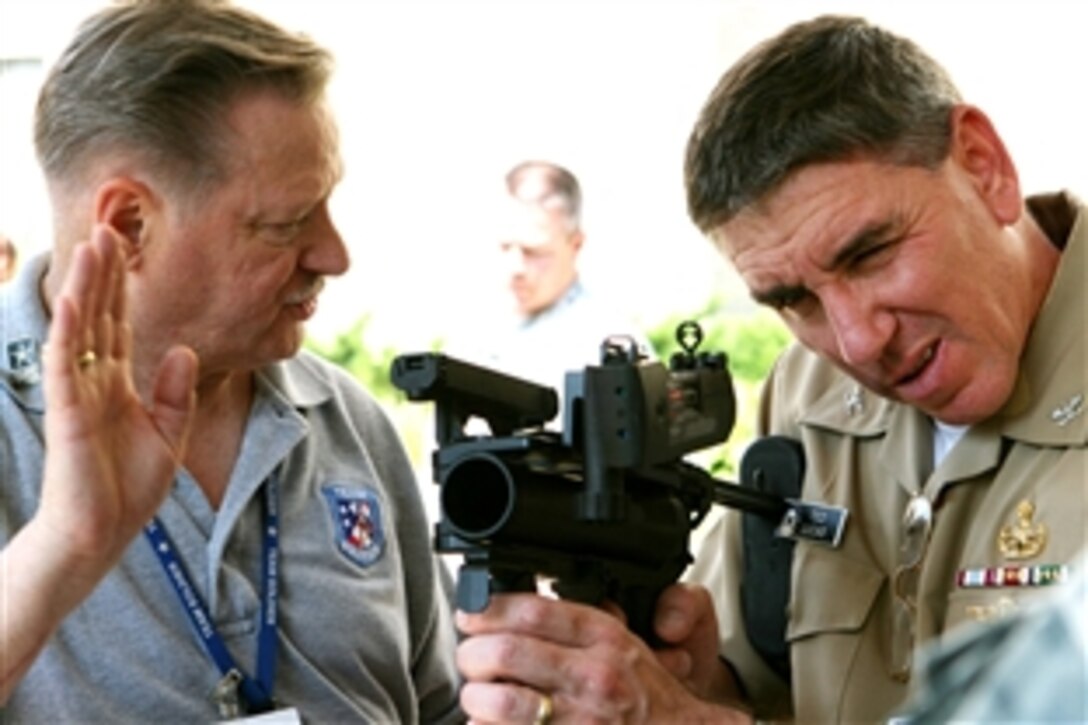 Ward Eldridge (left), exhibit manager, Program Executive Office Soldier, explains the XM320 Grenade Launcher to Navy Capt. Ted Lucas during a display June 13, 2008, in the Pentagon courtyard.  