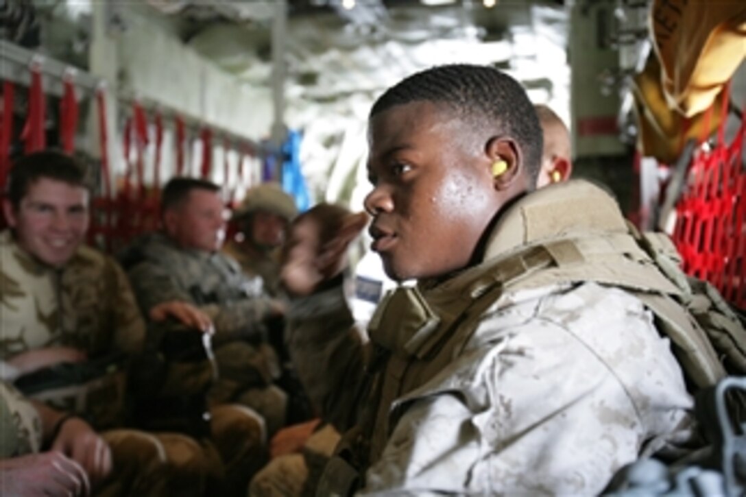 U.S. Navy Hospitalman Miranda, with 2nd Battalion, 7th Marine Regiment, waits aboard an aircraft to depart the Kandahar Air Field in Afghanistan headed to Camp Barber on June 3, 2008.  The Marine unit, based out of Marine Air Ground Combat Center Twenty-nine Palms, Calif., is a reinforced light infantry battalion.  
