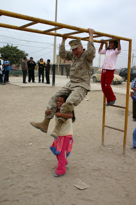 SAN CLEMENTE, Peru - LCpl  Anthony Eskew, 21, from New Oxford, PA., enjoying a break from the humanitarian action in San Clemente, Peru. Eskew is taking part in Partnership of the Americas 2008. A detachment from the Special Marine Air Ground Task Force 24 (SPMAGTF 24), under the leadership of LtCol John Klink, Executive Officer SPMAGTF 24, is currently helping the citizens of San Clemente by removing debris from the city streets as well as lending a hand at a local school by fixing the school playground. San Clemente was devastated last year when the city suffered an earthquake registering an 8.0 in the Richter scale. (Photo Maj Winston Jimenez)