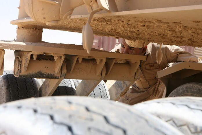 Lance Cpl. Enoch E. Chavarria, 21, a combat engineer with Route Clearance Platoon, 3rd Combat Engineer Battalion, Regimental Combat Team 5, visually inspects tires on a vehicle in Rawah, Iraq, June 12. The platoon travels throughout RCT-5's area of operations to find and clear improvised explosive devices that may cause harm to Coalition forces and Iraqi civilians. The platoon also aids the infantry battalions with patrols and escorts convoys as they travel throughout western Anbar province.