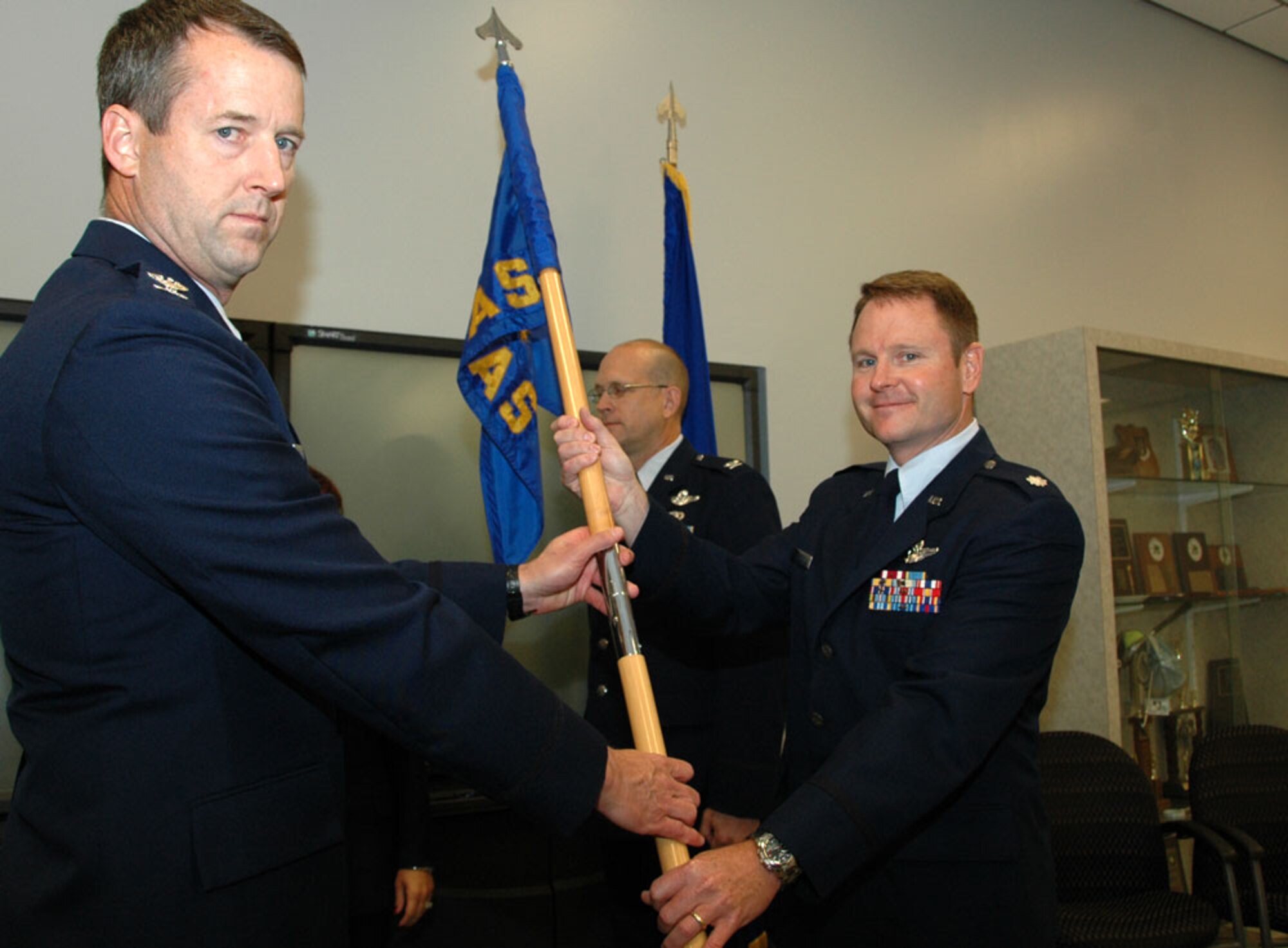 KEESLER AIR FORCE BASE, Miss. -- Lt. Col. Louis Patriquin (right) takes the reigns as the new commander for the 403rd Operations Group at a change of command ceremony held Saturday of the June Unit Training Assembly, replacing Col. Jay Jensen, who will be commanding the 315th Operations Group at Charleston Air Force Base, S.C. Before joining the 403rd Wing, Colonel Patriquin served as the deputy commander for the 512th Operations Group, Dover AFB, Del. The colonel stressed the need for reservists to focus on the Air Force mission, especially in this day and age when "the eyes of American are truly upon us." He believes that our Citizen Airman can better accomplish this goal by putting three main points into practice: taking care of our families, keeping our employers informed, and embracing the professions we choose to pursue in the Reserve. "The beauty of the Air Force Reserve is that we are here because we want to be here," said Patriquin. "It is our choice, and one that we should embrace." (U.S. Air Force Photo/Tech. Sgt. Ryan Labadens)