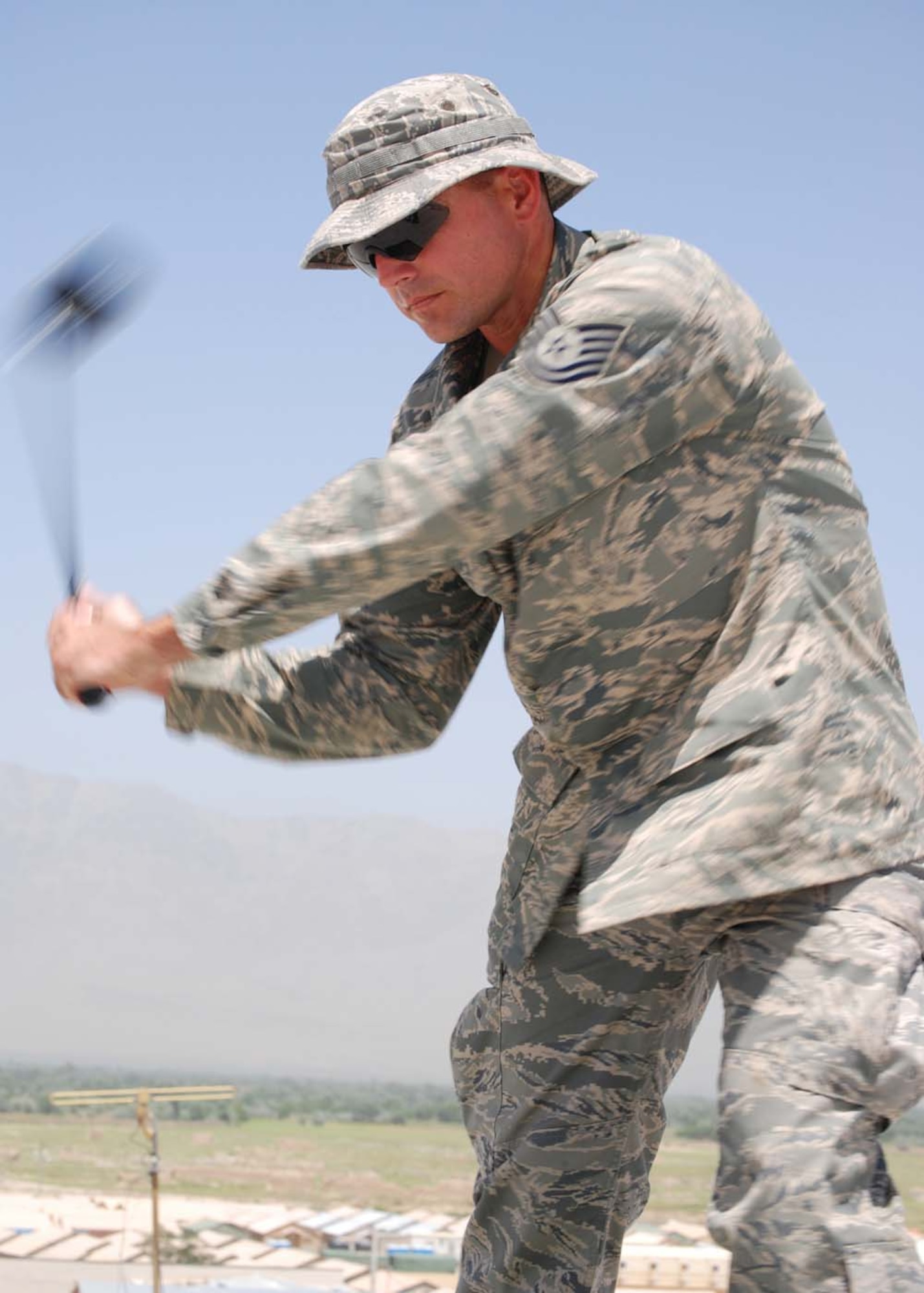 BAGRAM AIR FIELD, Afghanistan -- Tech. Sgt Britt Bare, a 10-time a year golfer, swing his Tiger Woods-signed driver he won in an American Forces Network radio contest conducted throughout the Operation Enduring Freedom theater. “Thanks Tiger, and thank you to America Supports You,” he said in appreciation for his contest winnings, which he said will stay in his family for a while. Tiger Woods and Nike donated autographed clubs and golf gear to servicemembers in Afghanistan, Iraq, United Kingdom, Germany, Japan, and aboard the U.S.S. Harry S. Truman. Sergeant Bare, deployed to the 455th Expeditionary Civil Engineer Squadron on Bagram Air Field from Malmstrom Air Force Base, Mont., signed a golf ball which will be sent back to the U.S., and used in the tournament. (U.S. Air Force photo by Staff Sgt. Stephen Ocenosak)