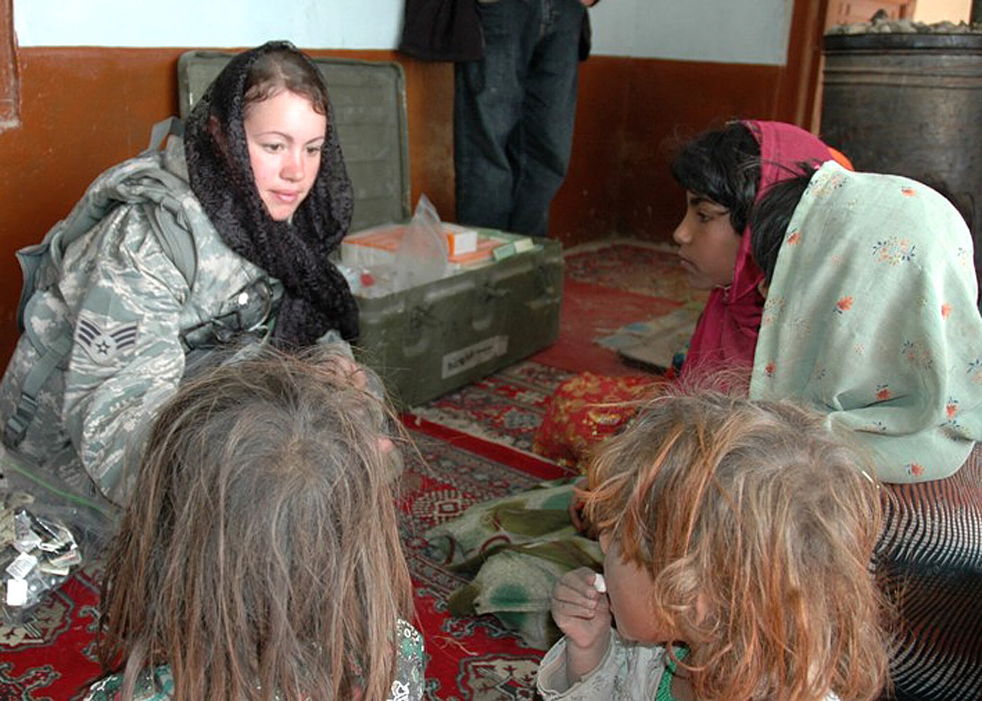 ZABUL PROVINCE, Afghanistan -- Senior Airman Felicita Torres-Perkins, Zabul Provincial Reconstruction Team medic, passes out internal parasite treatment medication to children in Jarullah village March 11. PRTs conduct civil-military operations throughout Afghanistan to help extend the reach of the Government of Afghanistan. Zabul PRT is the only U.S. team operating in Regional Command South. (U.S. Air Force photo by Capt. Jean Duggan)