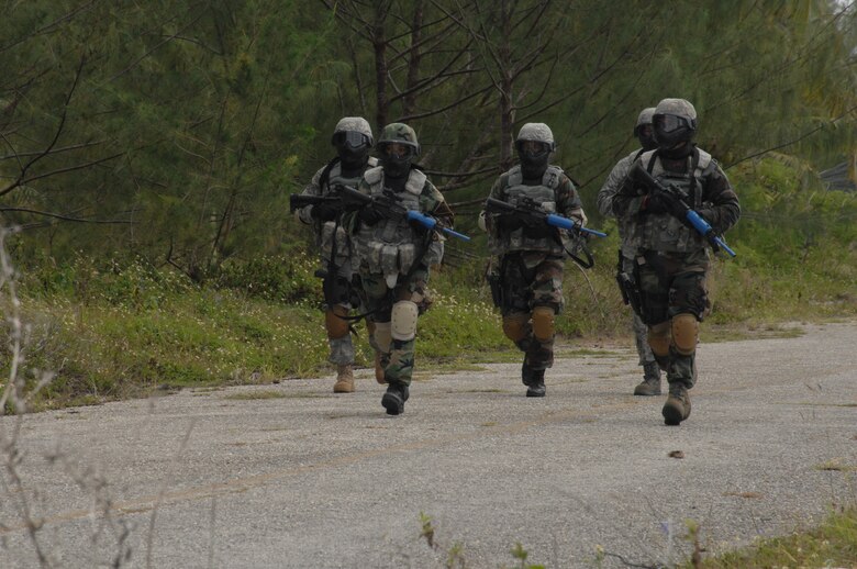 PACAF airmen run toward the entry control point of the training base during the tactical weapons simualtion portion of Commando Warrior on June 14 at Andy South here. Commando Warrior is a seven day pre-deployment training for PACAF's Security Forces airmen hosted by the 736th Security Forces Squadron, Andersen AFB, Guam.(U.S. Air Force photo by Airman 1st Class Nichelle Griffiths)
