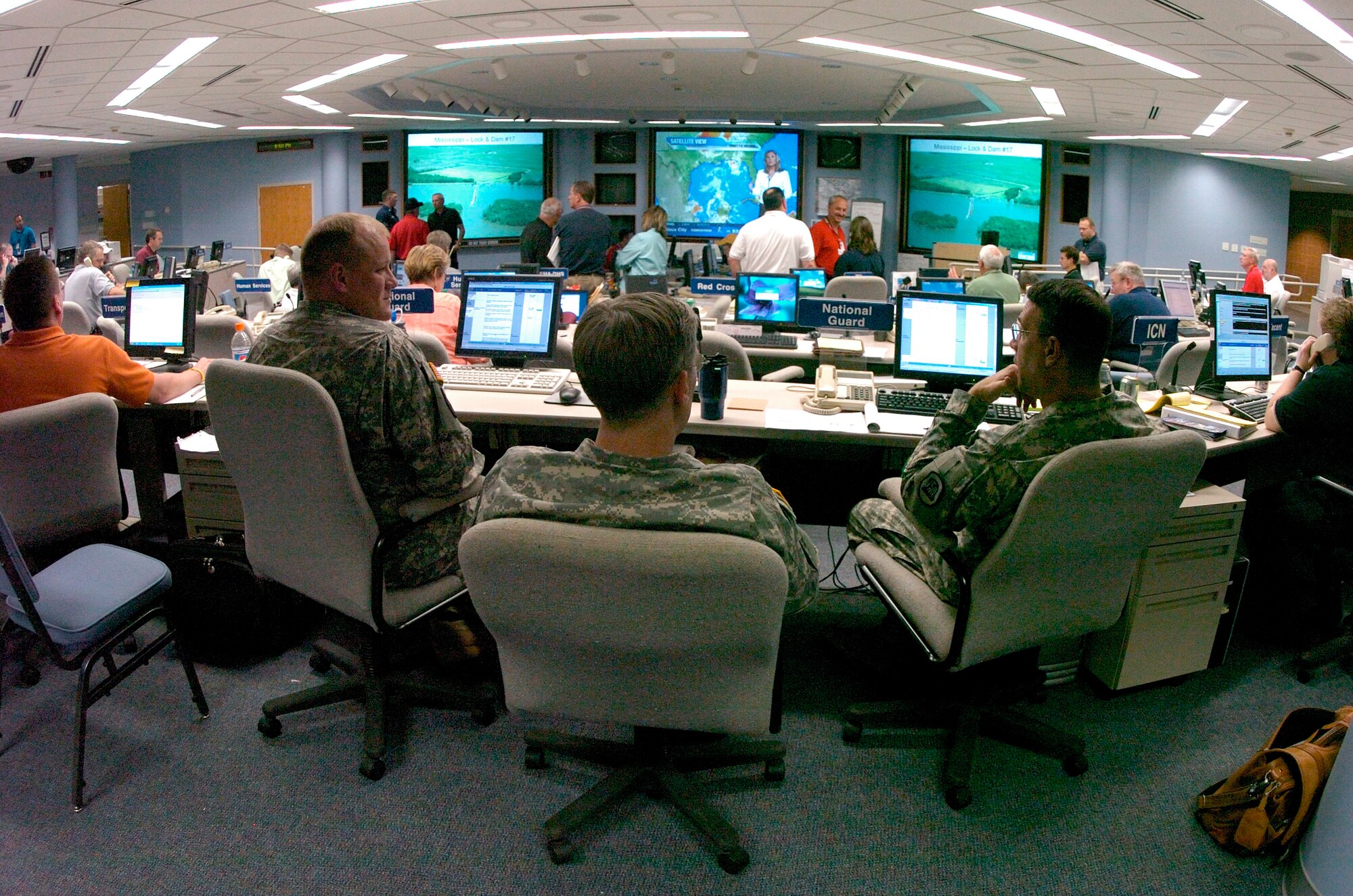 Air and Army National Guard members and Iowa state officials make sure flood tasking are fed through the proper channels June 14 at the Iowa National Guard Headquarters in Camp Dodge, Iowa. More than 2,500 National Guard Soldiers and Airmen are currently activated for flood-response operations in Iowa. (U.S. Air Force photo/Staff Sgt. Desiree N. Palacios) 