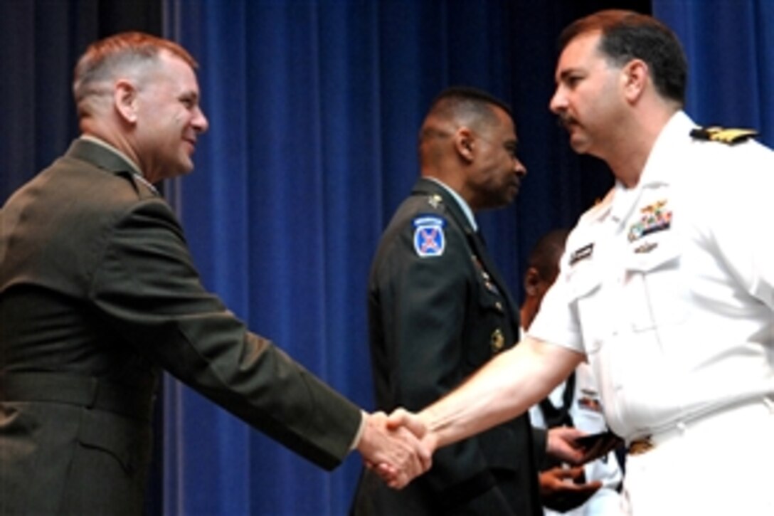 Marine Gen. James E. Cartwright, left, vice chairman of the Joint Chiefs of Staff, congratulates a graduate at the Joint Forces Staff College graduation, June 13, 2008, in Norfolk, Va. Cartwright was the guest speaker at the graduation. 