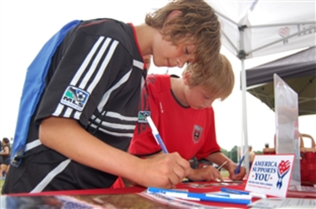 Soccer fans Danny Zilevicius, left, and Timothy Murnin express their thanks to the troops at the America Supports You booth set up during D.C. United’s 9th Annual Armed Forces and Veterans Appreciation Day, June 14, 2008, in Washington, D.C. 