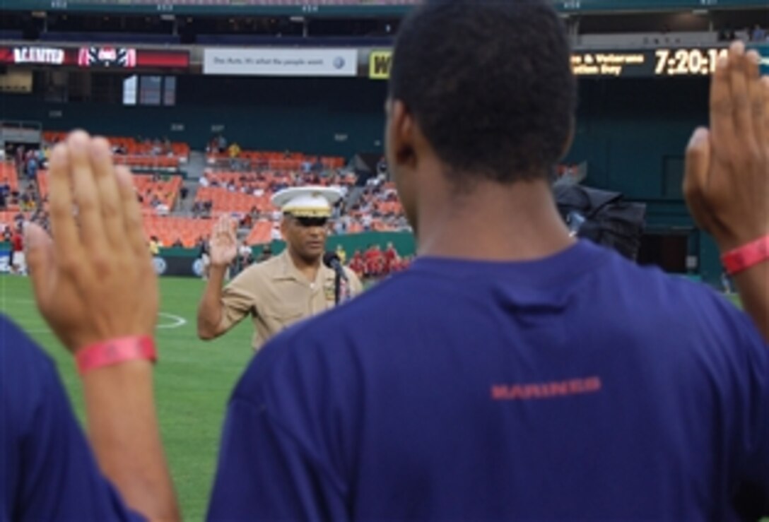 Lt. Gen. Ronald Coleman, deputy Marine Corps commandant for manpower and reserve affairs, administers the oath of enlistment to people joining the military during D.C. United’s 9th Annual Armed Forces and Veterans Appreciation Day, June 14, 2008, in Washington, D.C. 