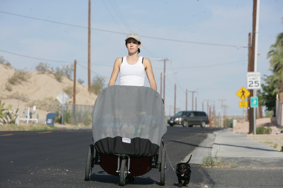 Erica McNicoll, wife of 1st Lt. Michael McNicoll, platoon commander with Weapons Company, 2nd Battalion, 7th Marine Regiment, participates in the “I Ran to Afghanistan” program with her twin daughters, Ashley and Kaitlyn, to show support to her husband and other 2/7 Marines and sailors during their deployment scheduled to end this fall.