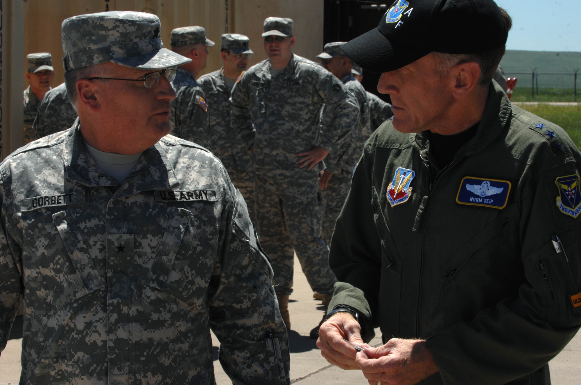 Army Brig. Gen. Keith Corbett, South Dakota National Guard assistant adjutant, coins Lt. Gen. Norman Seip, 12th Air Force commander, here, June 14. The coin served as a token of appreciation from the Army to General Seip for his visit to the training sites of the 2008 Golden Coyote exercise. (U.S. Air Force photo/Airman Corey Hook)






