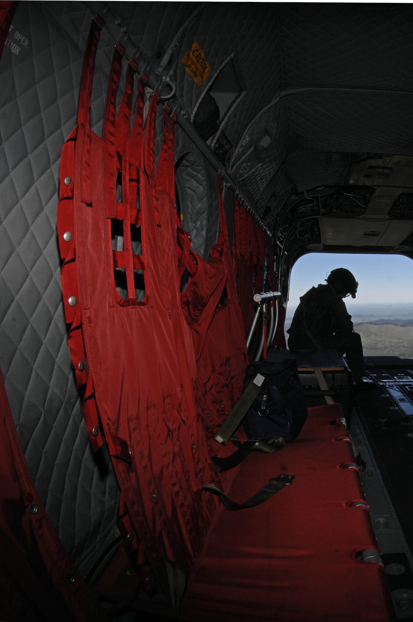 Second Warrant Officer Foo Siew Wah, Singapore Armed Forces flight engineer, flys on a CH-47 Chinook helicopter near Camp Rapid, S.D., June 14. The helicopter landed at Ellsworth to pick up Lt. Gen. Norman Seip, 12th Air Force commander, who toured the various training sites involved in the 2008 Golden Coyote exercise. (U.S. Air Force photo/Airman Corey Hook)




