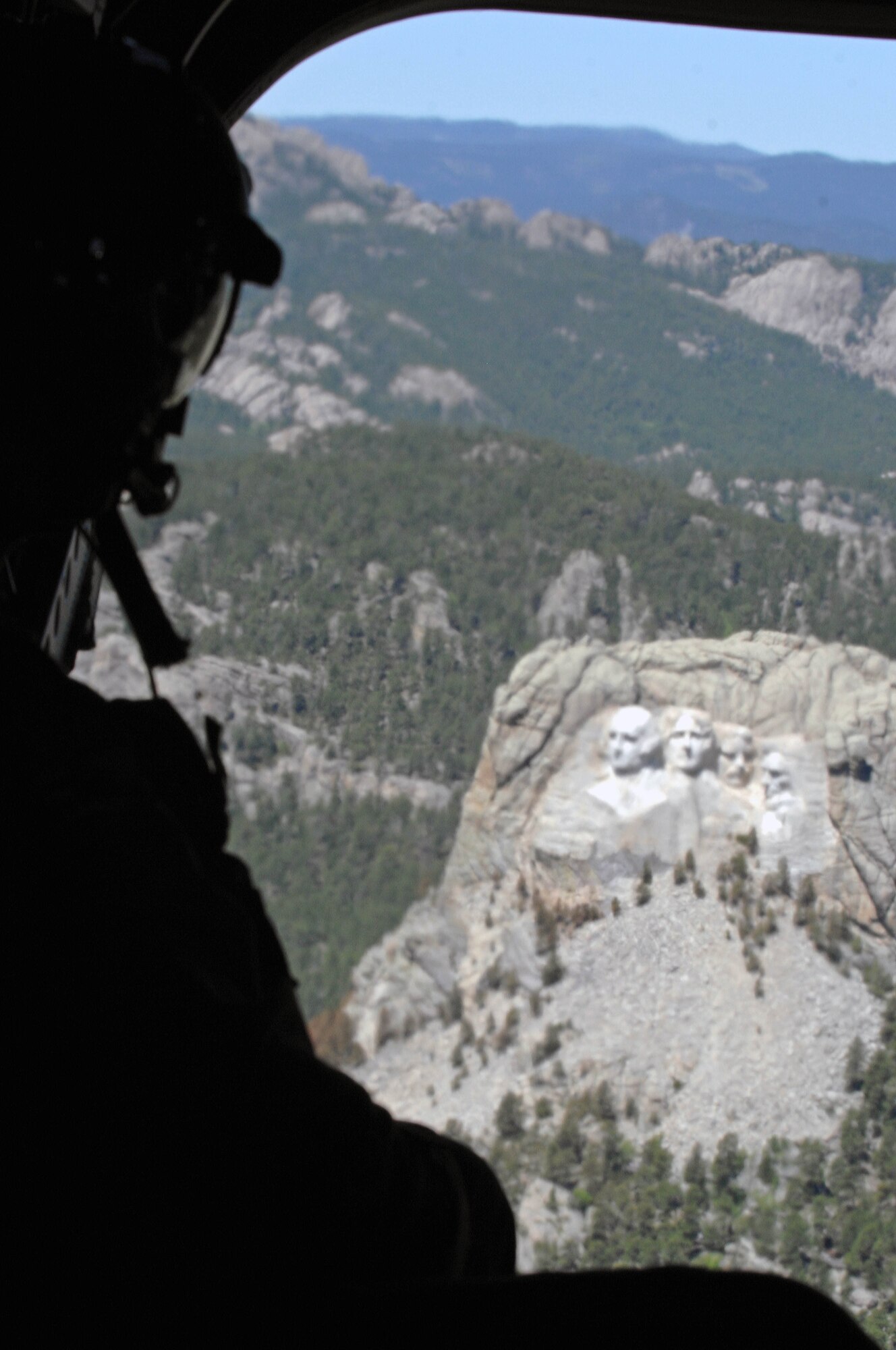 Second Warrant Officer Foo Siew Wah, Singapore Armed Forces flight engineer, views at Mount Rushmore from a CH-47 Chinook helicopter near Keystone, S.D., June 14. The helicopter tour allowed Lt. Gen. Norman Seip, 12th Air Force commander, to visit Army and Air Force personnel involved with the South Dakota National Guard Golden Coyote training exercise. (U.S. Air Force photo/Airman Corey Hook)



