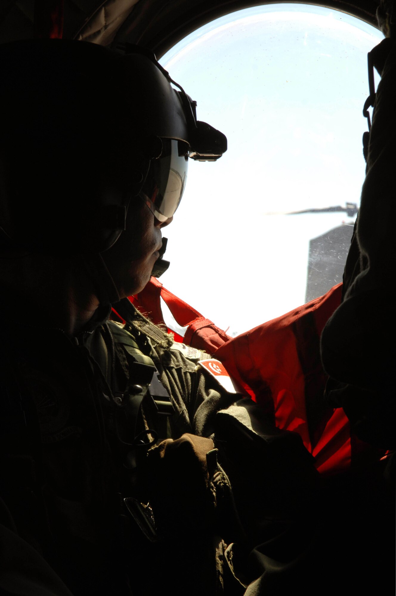 Second Warrant Officer Foo Siew Wah, Singapore Armed Forces flight engineer, awaits liftoff in a CH-47 Chinook helicopter here, June 14. The flight was carried out for Lt. Gen. Norman Seip, 12th Air Force commander, to get a first-hand look at the training sites of the 2008 Golden Coyote exercise. (U.S. Air Force photo/Airman Corey Hook)

