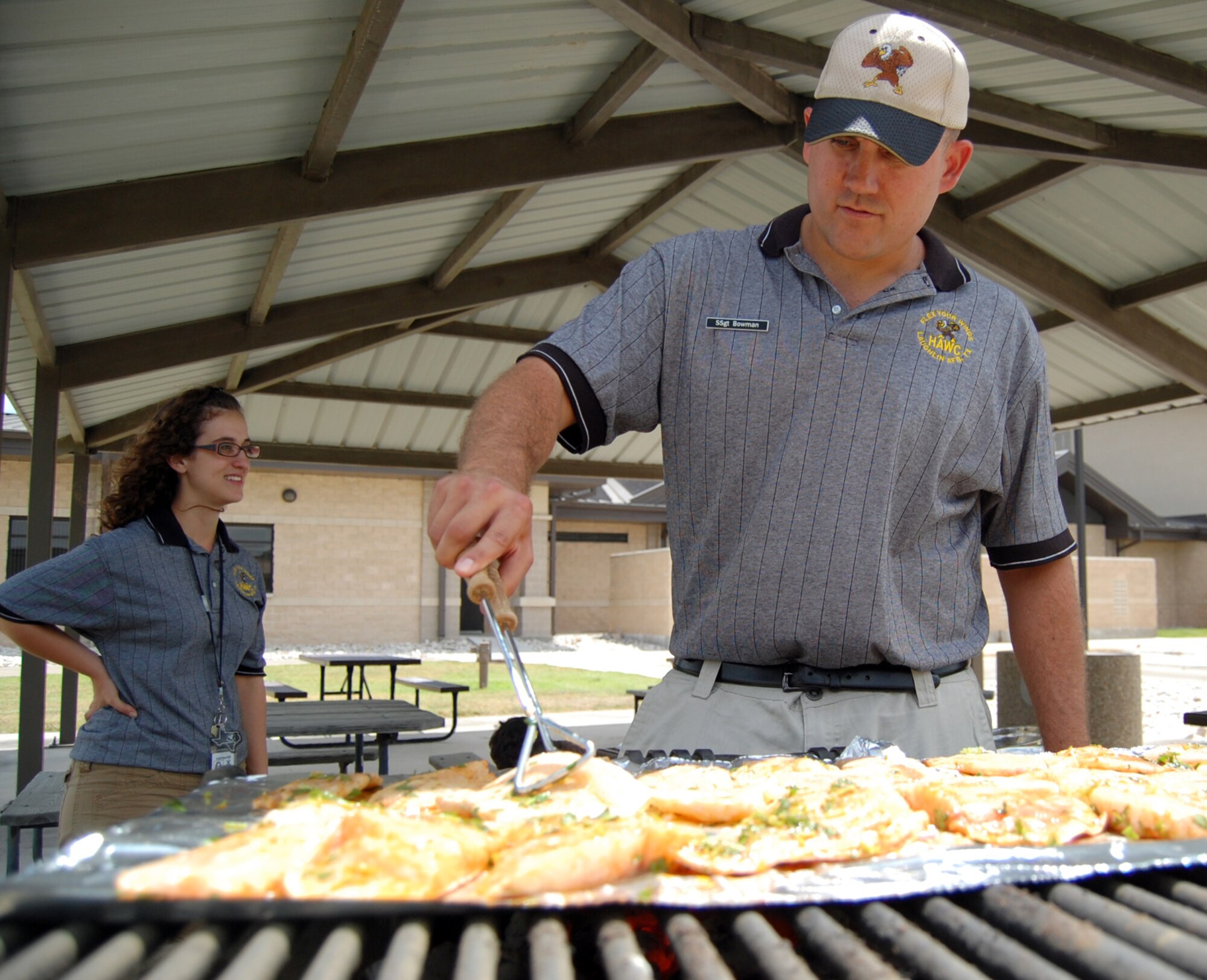 LAUGHLIN AIR FORCE BASE, Texas -- Staff Sgt. Kenneth Bowman, Laughlin Health and Wellness Center, grills filets of fish as part of a healthy cooking demonstration June 13.  Those who attended the demonstration, which focused on grilling, were introduced to the "Bad Fats Brothers," an animated duo who starred in a comical look at trans and saturated fats.  The HAWC hosts regular cooking demonstrations to promote a healthy lifestyle and introduce new methods of cooking to Team XL.  (U.S. Air Force photo by Staff Sgt. Austin M. May)
