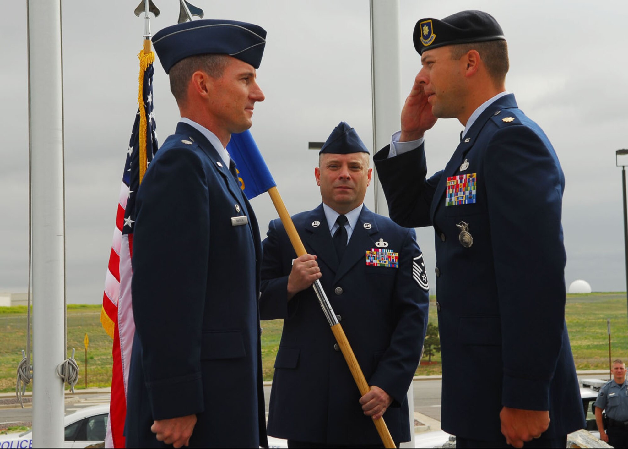 BUCKLEY AIR FORCE BASE, Colo. -- Maj. Matthew Boschert accepts command of the 460th Security Forces Squadron from Lt. Col. Edward Madsen, 460th Logistics Readiness Squadron commander and acting 460th Mission Support Group deputy commander, at a change of command ceremony here June 16. (U.S. Air Force photo by Airman 1st Class Alex Gouchnour)