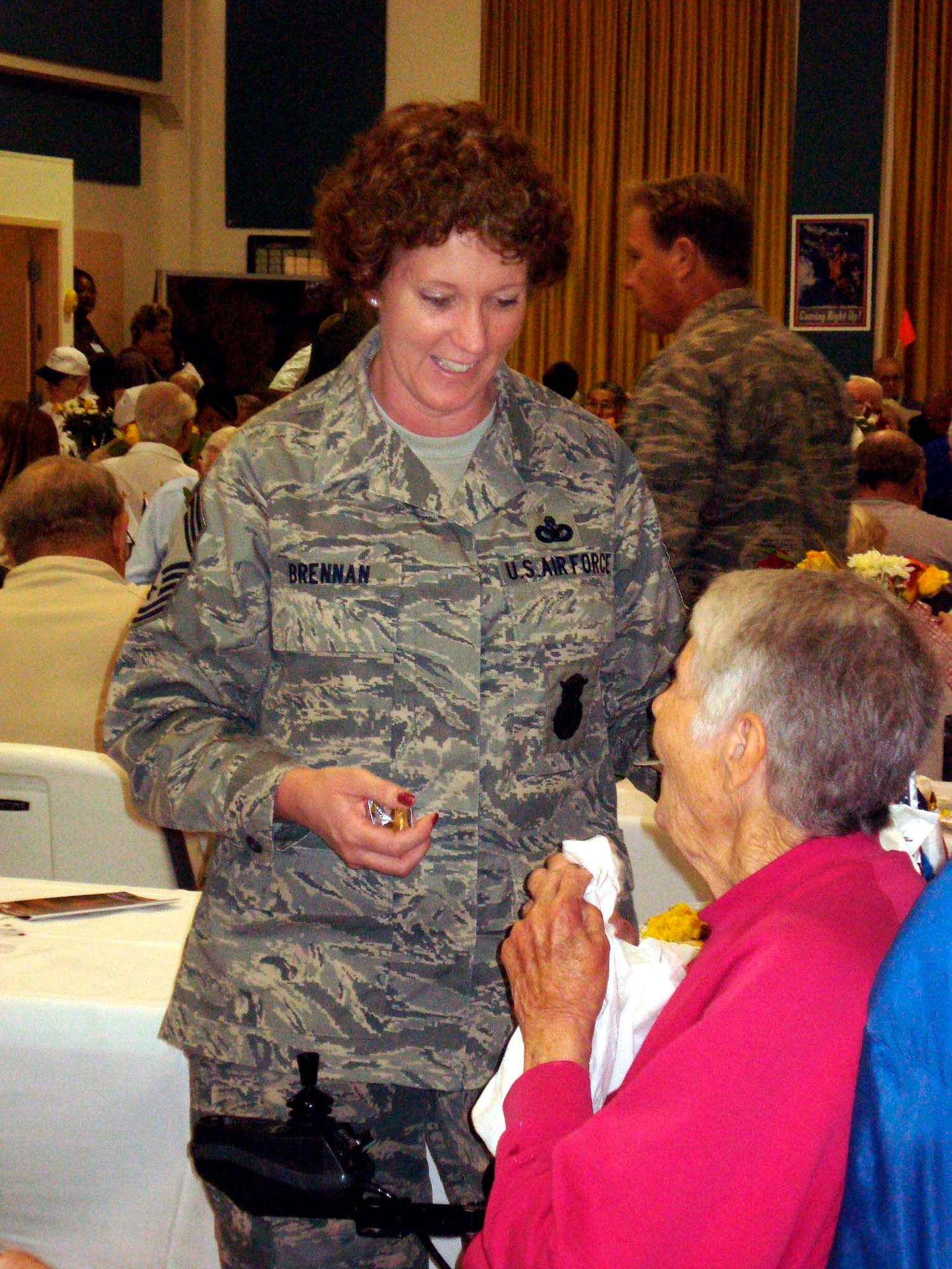 TRAVIS AIR FORCE BASE, Calif. -- You've got a friend: Chief Master Sgt. Tamara Brennan visits with residents at Yountville Veteran's Home during Operation Gratitude June 14. (US Air Force photo by Staff Sgt. Meredith Mingledorff) 