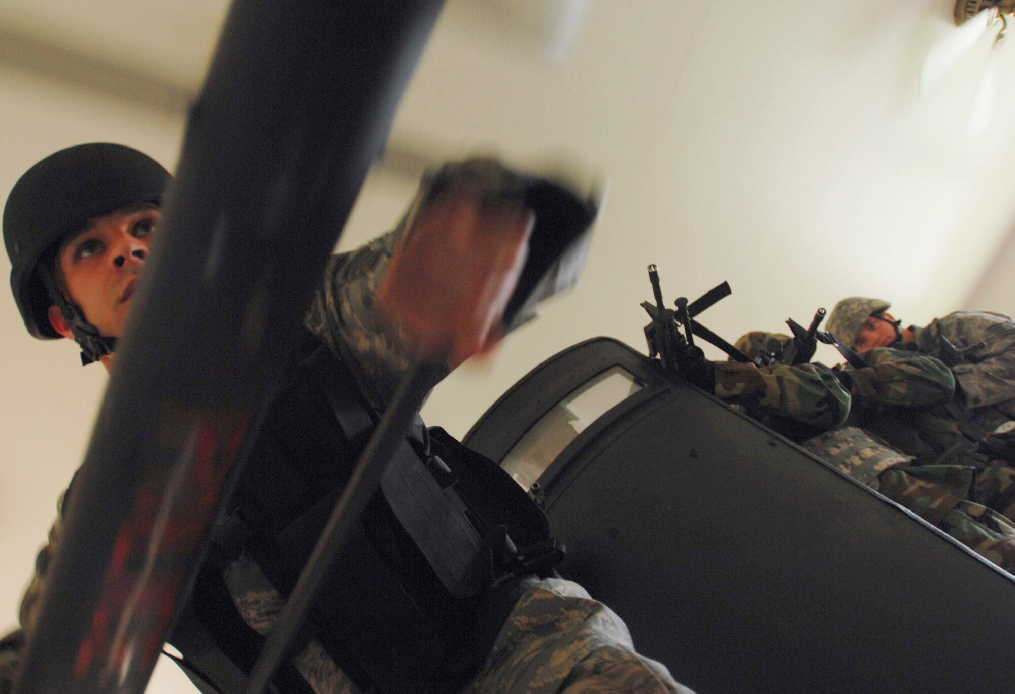Staff Sgt. Dean Martinez uses a breeching tool to knock down a barricaded door as the rest of the Security Forces Special Emergency Response Team members await access to the room during a counter-terrorism exercise June 9 at Eielson Air Force Base, Alaska. Training exercises keep security forces personnel current on policies and procedures involving hostage retrieval, barricade subjects and counter-terrorism. (U.S Air Force photo/Tech. Sgt. Eric T. Sheler) 