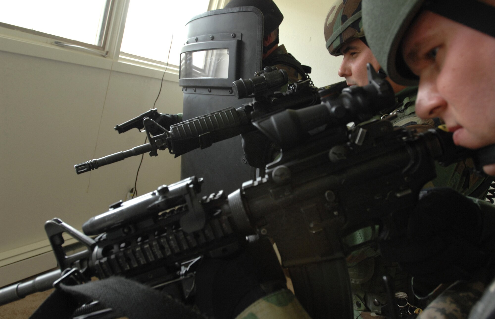 Master Sgt. Shawn Cox (right to left), Tech. Sgt. Dennis Keller and Senior Airman Brad Hickey surround a suspect who has barricaded himself in June 9 during a counter-terrorism exercise at Eielson Air Force Base, Alaska. The Security Forces Special Emergency Response Team members train to stay current on the policies and procedures involving hostage retrieval, barricaded subjects and counter-terrorism. SERT is the Air Force Security Forces equivalent to civilian police forces SWAT team. (U.S Air Force photo/Tech. Sgt. Eric T. Sheler) 