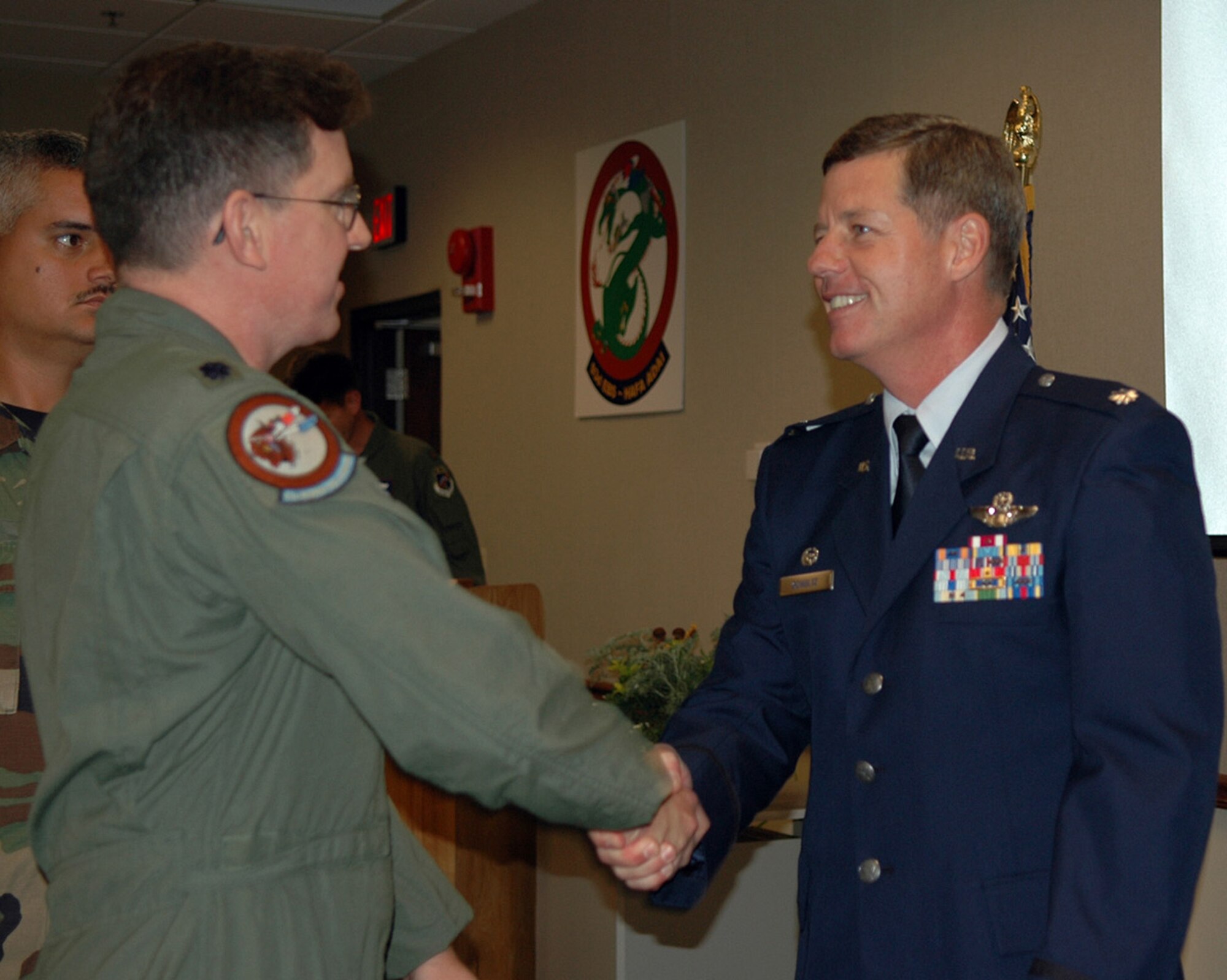 Lt. Col. Keith Schultz, new 93d Bomb Squadron commander, shakes the hand of a squadron member at the 93 BS assumption of command ceremony Saturday, July 7, held at the 93d BS operations building. (U.S. Air Force photo/Senior Master Sgt. Jessica D'Aurizio)