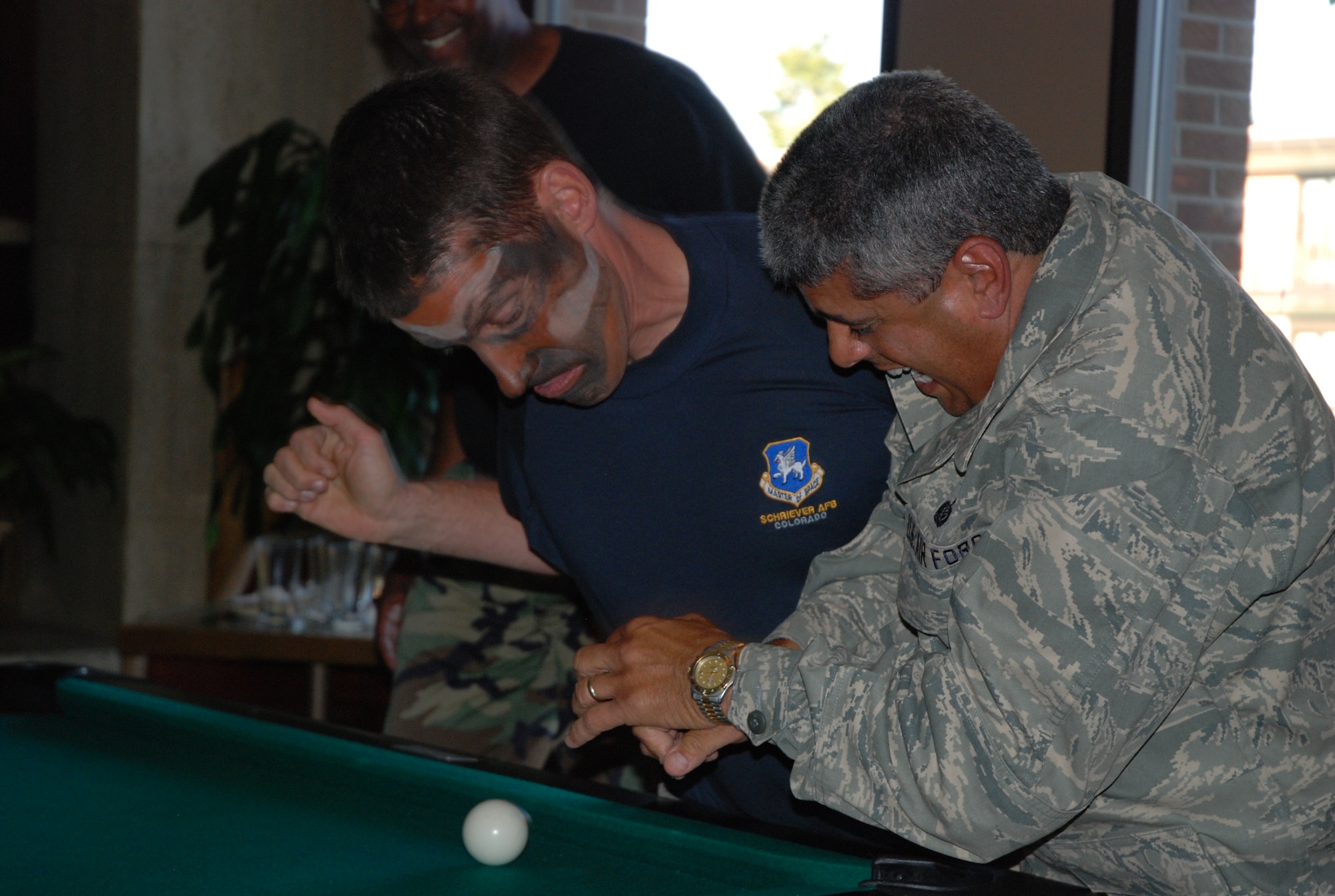 Col. Robert Skinner, 50th Network Operations Group commander, edges Col. Manual Hidalgo, 21st Mission Support Group commander, away from shooting position during the final round of the June 13 CRUD tournament at the Peterson Air Force Base Club in Colorado. The 50th Space Wing defended their CRUD title by holding onto the coveted trophy. (Air Force photo/2nd Lt. Jonathan Simmons)