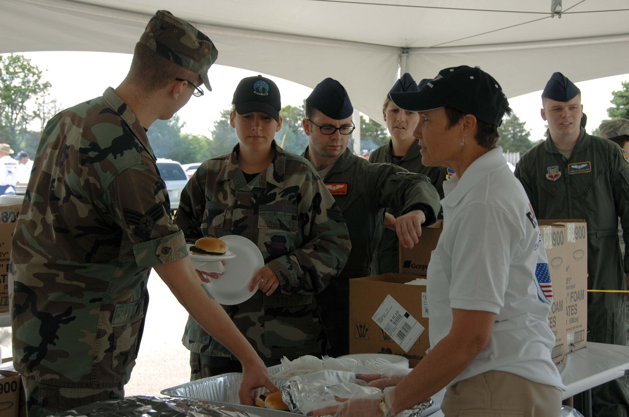 Team Offutt members enjoy the free hamburgers, hot dogs and other fare served at the picnic. All of the food was donated by local businesses in appreciation of the hard work of Offutt’s military men and women. (U.S. Air Force Photo By/Charles Haymond)