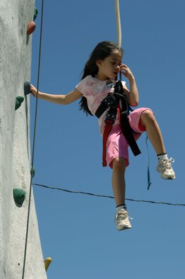 The daughter of a Team Offutt member tries her hand at the rock climbing wall at the Offutt Advisory Council’s Annual Appreciation Day Picnic. There were many activities available for children including face painting, games and prize giveaways. (U.S. Air Force Photo By/Charles Haymond)