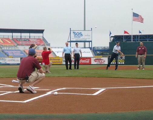Gen. Kevin Chilton, commander of U.S. Strategic Command, throws the first pitch druing Military Appreciation Day at Rosenblatt Stadium June 8 while Col. Robert Maness, 55th Wing vice commander, waits for his turn on the mound. The annual Military Appreciation Day game featured the Omaha Royals against the Iowa Cubs. (U.S. Air Force Photo By/Jeff Gates)