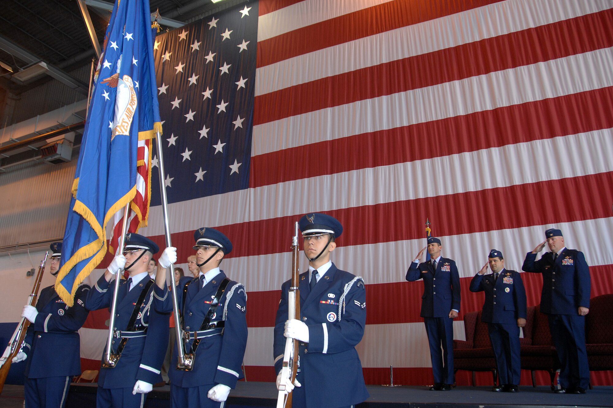 Brig. Gen. James Jones, 55th Wing commander, Col. Phillip Smith and Col. Jeffrey Herd render proper courtesy to the flag at the 55th Operations Group change of command ceremony June 5. Herd assumed command of the Air Combat Command’s largest group which has operational control over 12 squadrons and two detachments worldwide and consists of about 3,200 personnel. (U.S. Air Force Photo By/Josh Plueger)