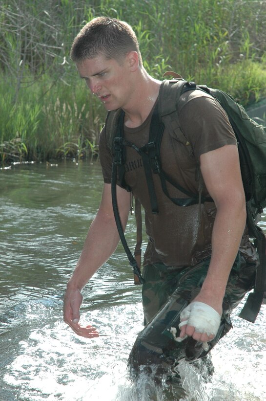 An Air Force Academy cadet wades his way through a creek during a Monster Mash at Hurlburt Field, Fla., June 13. The Monster Mash was a six-mile obstacle course designed to test the physical and mental abilities of would-be special tactics officers. The cadets were volunteers taking part in the Special Tactics Officer Orientation Course held here June 2-19. (U.S. Air Force photo/Master Sgt. Buffy Galbraith)