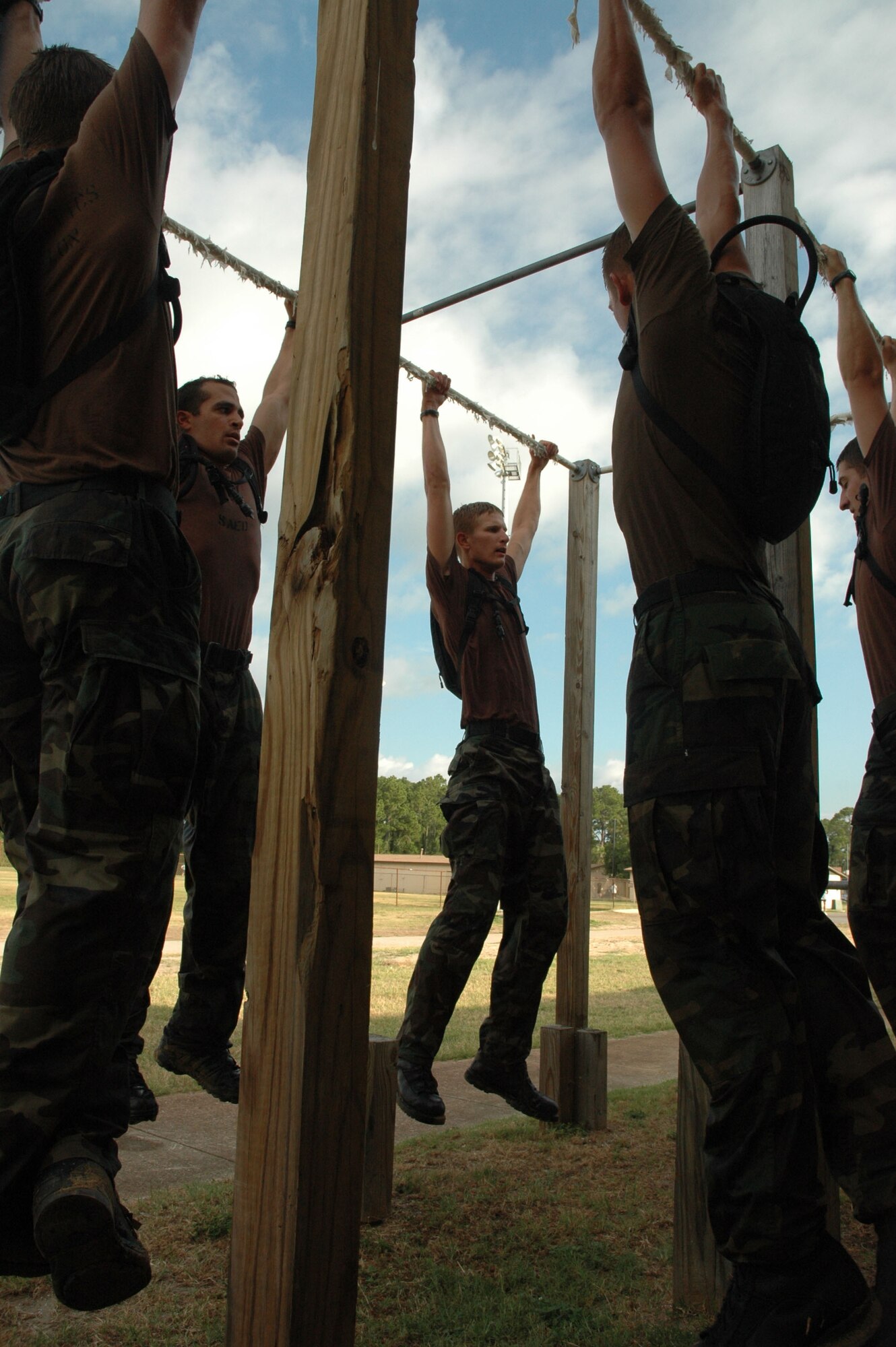 Air Force Academy cadets perform pull-ups together during a Monster Mash at Hurlburt Field, Fla., June 13. The Monster Mash was a six-mile obstacle course designed to test the physical and mental abilities of would-be special tactics officers. The Monster Mash was a six-mile obstacle course designed to test the physical and mental abilities of would-be special tactics officers. The cadets were volunteers taking part in the Special Tactics Officer Orientation Course held here June 2-19. (U.S. Air Force photo/Master Sgt. Buffy Galbraith).