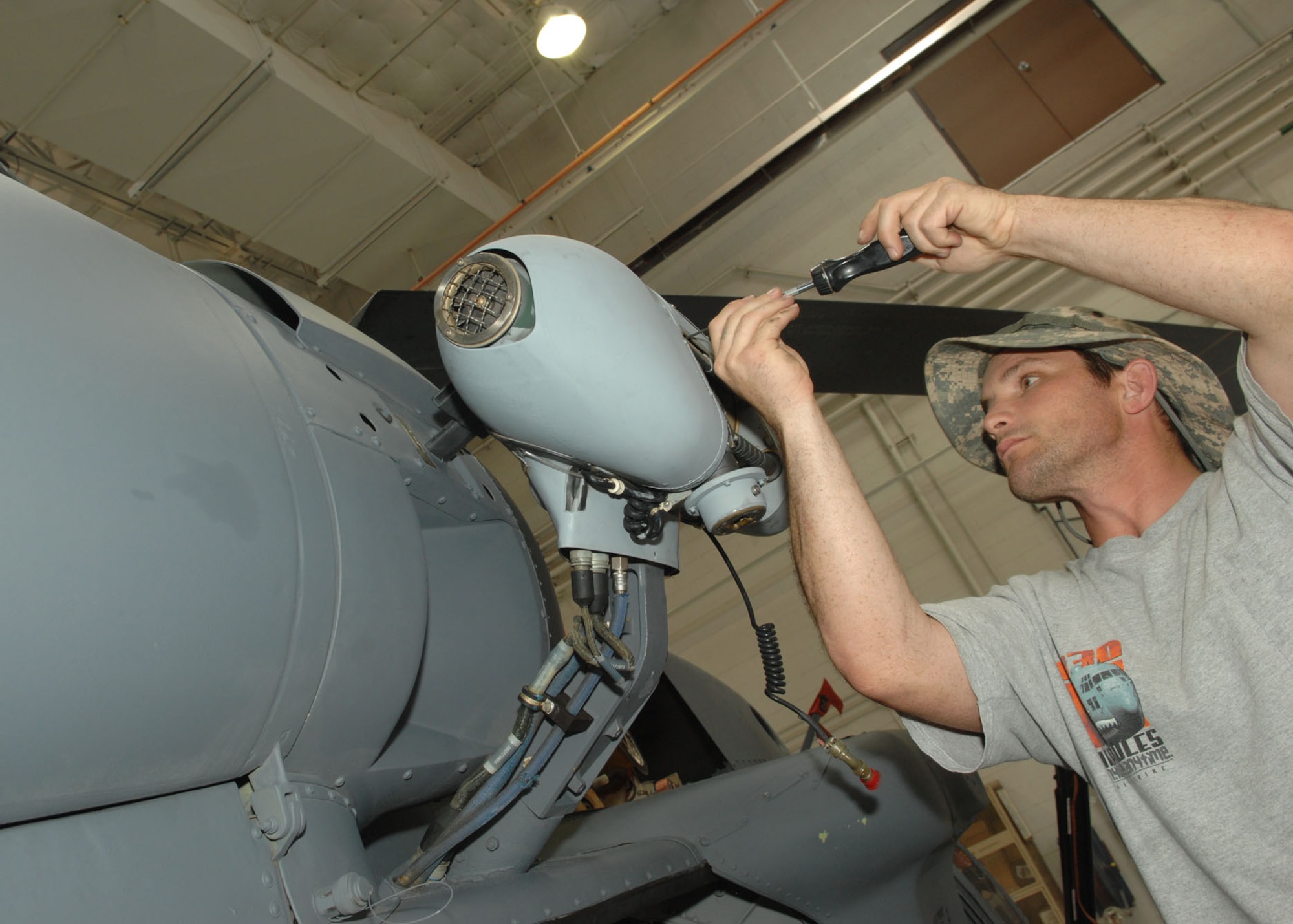 Mr. Cosimo Cosentino, Helicopter Crew Chief Air Reserve Technician, replaces a rescue hoist cable on a local HH-60 helicopter during the units June training weekend. Mr. Cosentino was a C-130 Crew Chief for 8 years on active duty before he transitioned into the Reserves.  (U.S. Air Force photo by Senior Airman Alesia Goosic) 