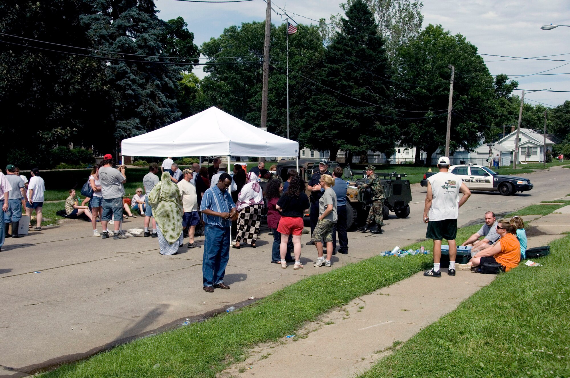Residents of Cedar Rapids, Iowa, wait at a checkpoint to hear if they will to be allowed to return home after massive flooding overwhelmed much of the city. (U.S. Air Force photo/Master Sgt. Jack Braden) 
