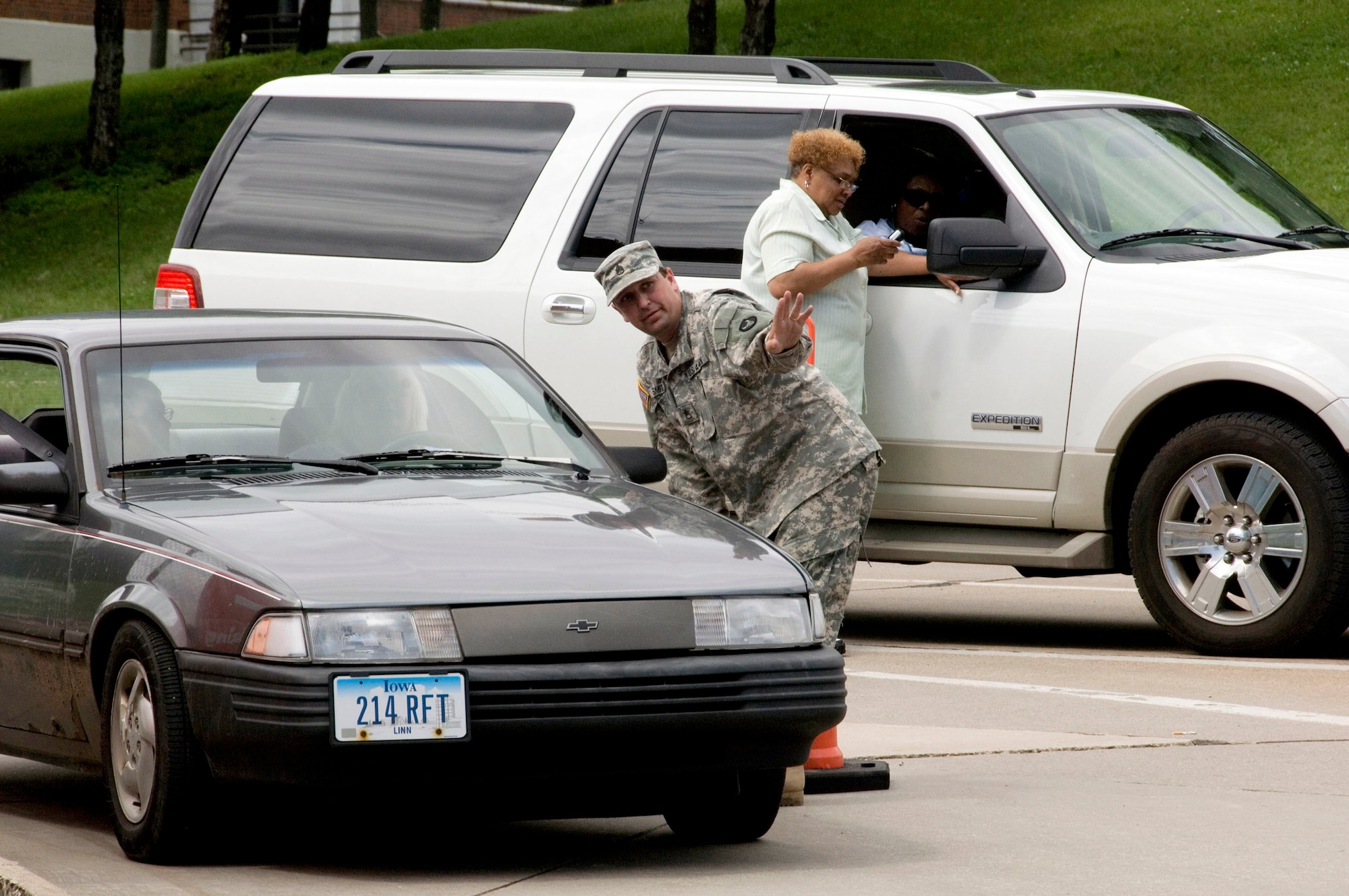 Staff Sgt. David Smith gives detour directions to a resident trying to return home after massive flooding in Cedar Rapids, Iowa. Sergeant Smith is a Guardsman with the Headquarters and Headquarters Company 2 Brigade Combat Team. He is from Boone, Iowa, and was activated to help with recovery efforts in Cedar Rapids, Iowa. (U.S. Air Force photo/Master Sgt. Jack Braden) 