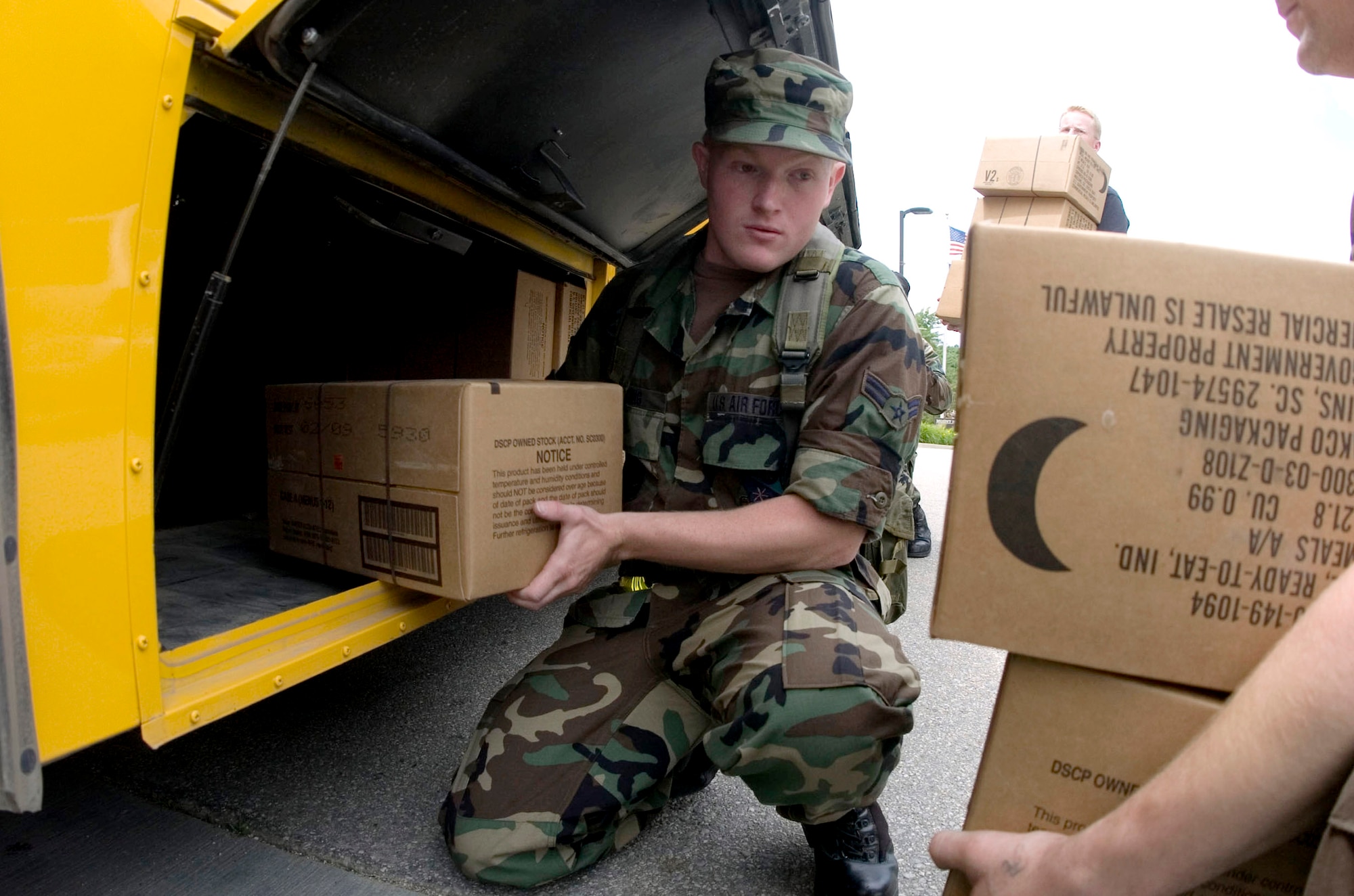 Airman 1st Class Dan DeJong unloads a school bus filled with Meals, Ready to Eat and sleeping bags  at Mount Mercy College, Cedar Rapids, Iowa, June 15. More than 150 Airmen arrived in Cedar Rapids to help secure and recover areas that were affected by flood waters. Airman DeJong is assigned to the 185th Air Refueling Wing located in Sioux City, Iowa. (U.S. Air Force photo/Staff Sgt. Desiree N. Palacios) 
